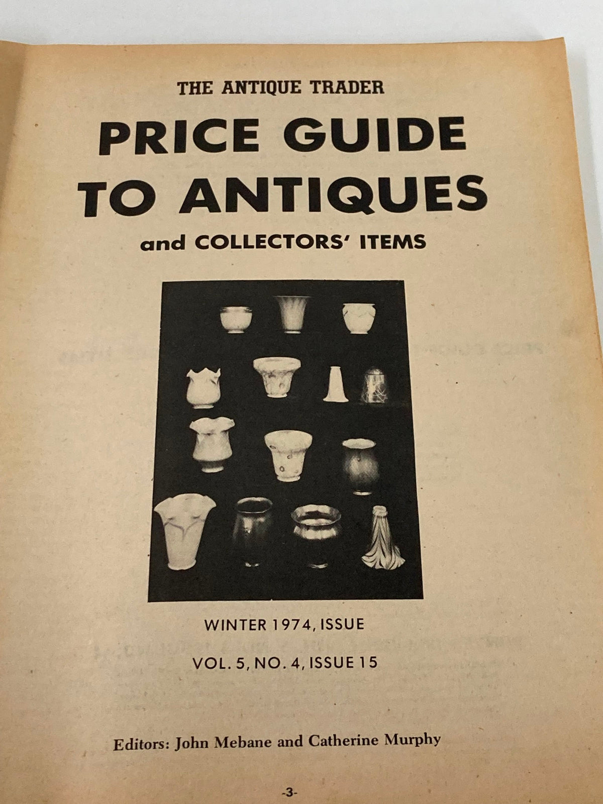 Interior page from The Antique Trader Winter 1974 Price Guide to Antiques and Collector's Items showing a collection of antique items and the magazine's title.