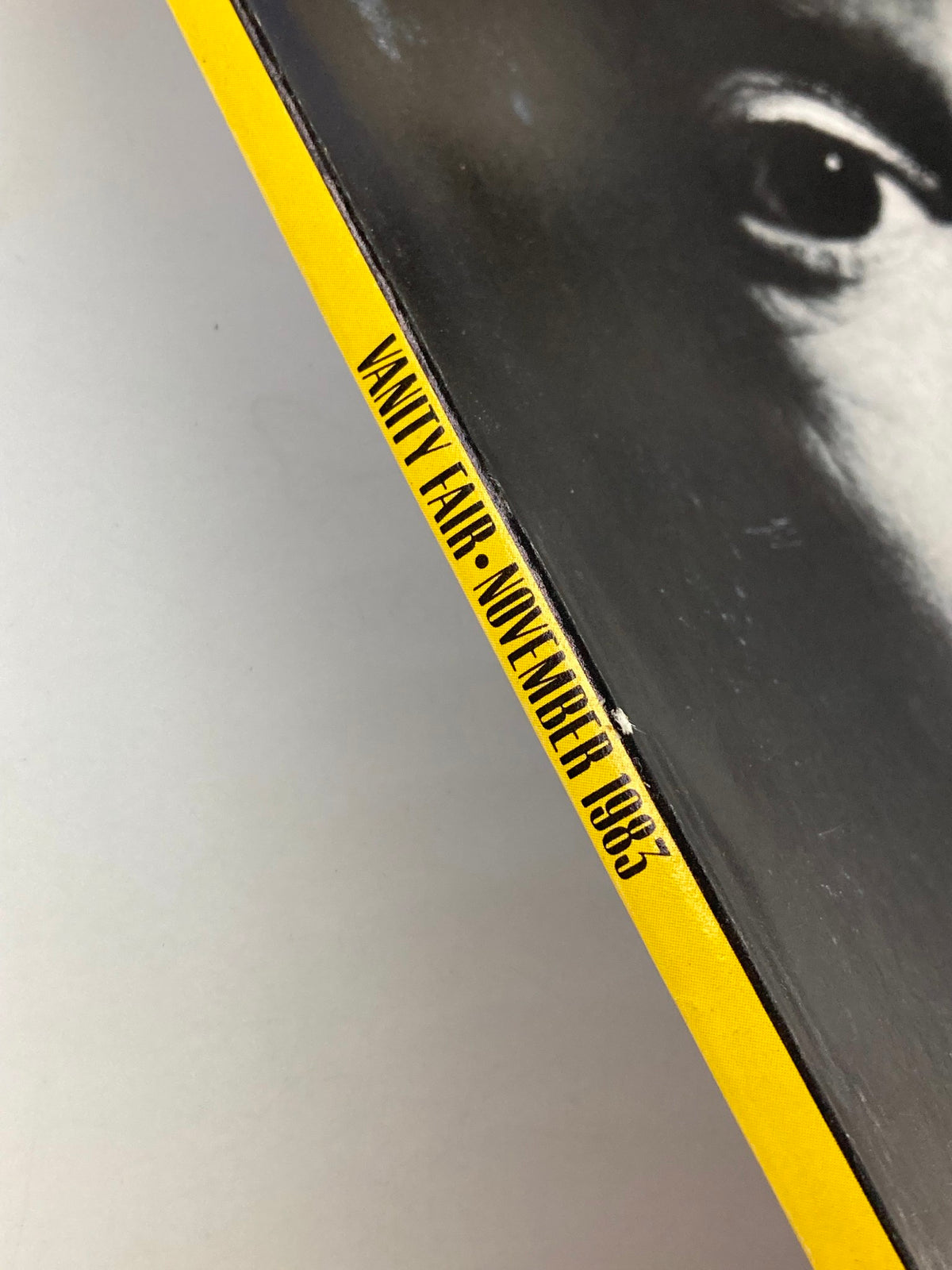 Side view of VTG Vanity Fair Magazine November 1983, highlighting the distinctive yellow spine with the issue title and date.