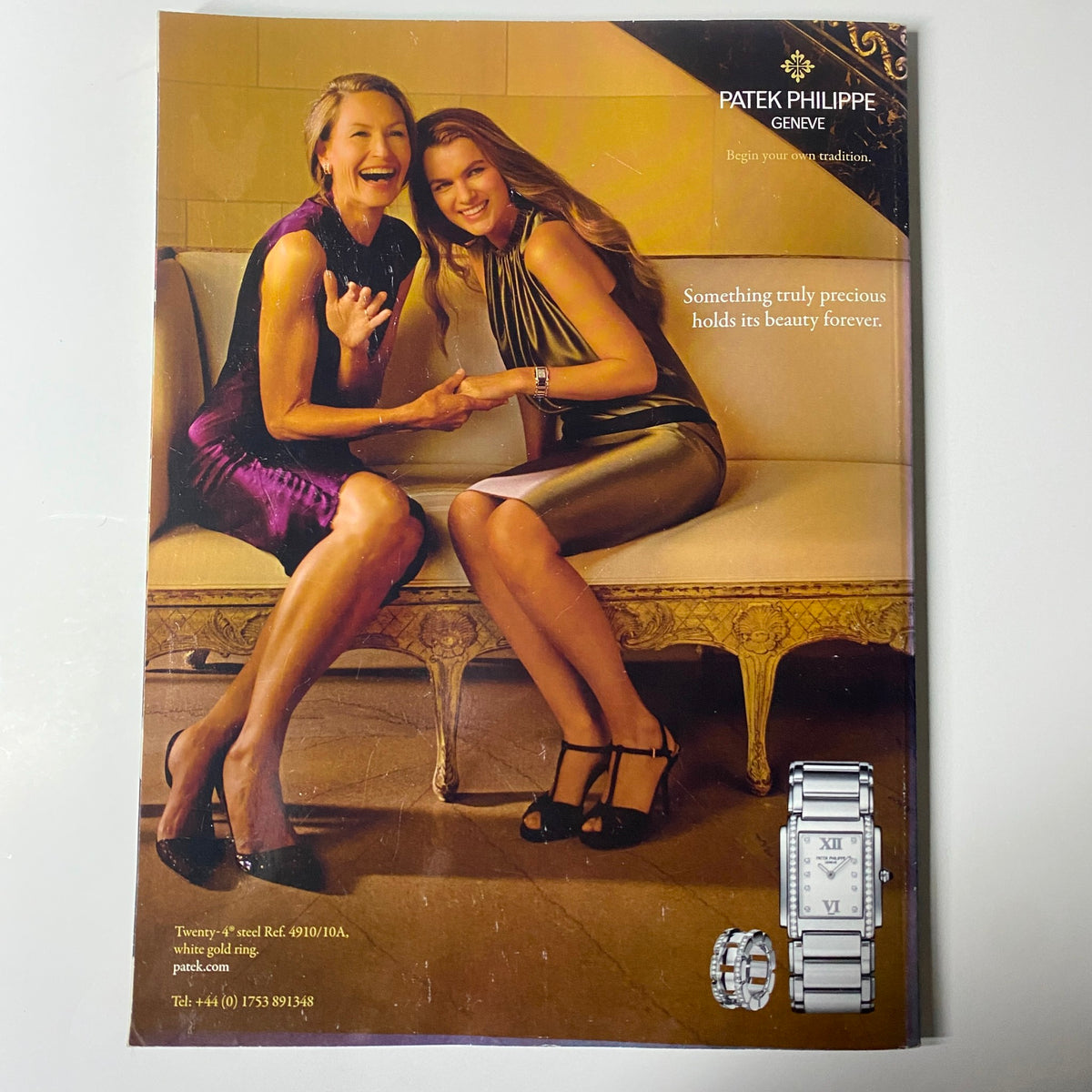 Patek Philippe advertisement featuring two women in elegant attire, emphasizing timeless luxury in Harper's Bazaar UK Magazine July 2012.