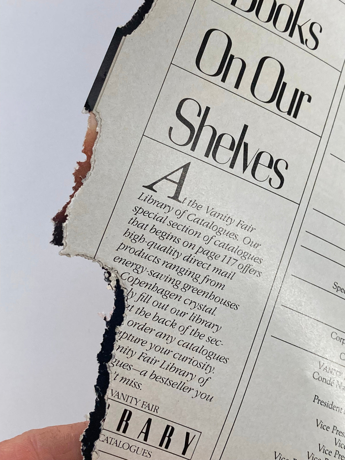 Torn corner of a vintage magazine page from the VTG Vanity Fair Magazine March 1984, revealing the wear indicative of its age, perfect for collectors.