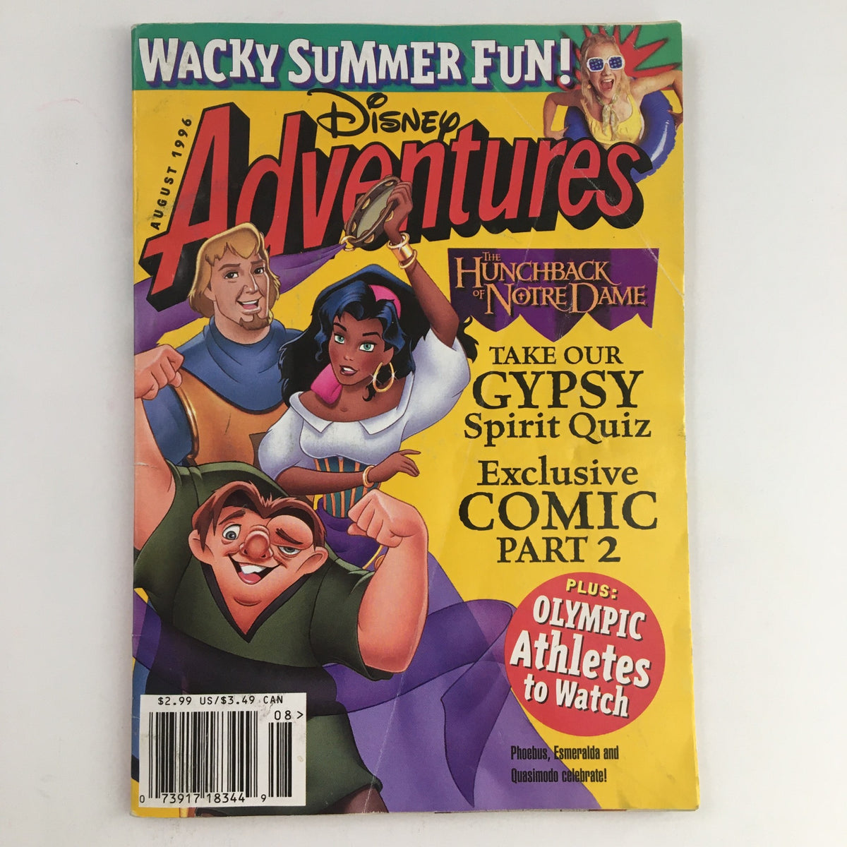 Disney Adventures Magazine August 1996 featuring The Hunchback of Notre Dame. Cover showcases main characters including Quasimodo, Esmeralda, and Phoebus, with a vibrant yellow background and text highlighting quizzes and comics.