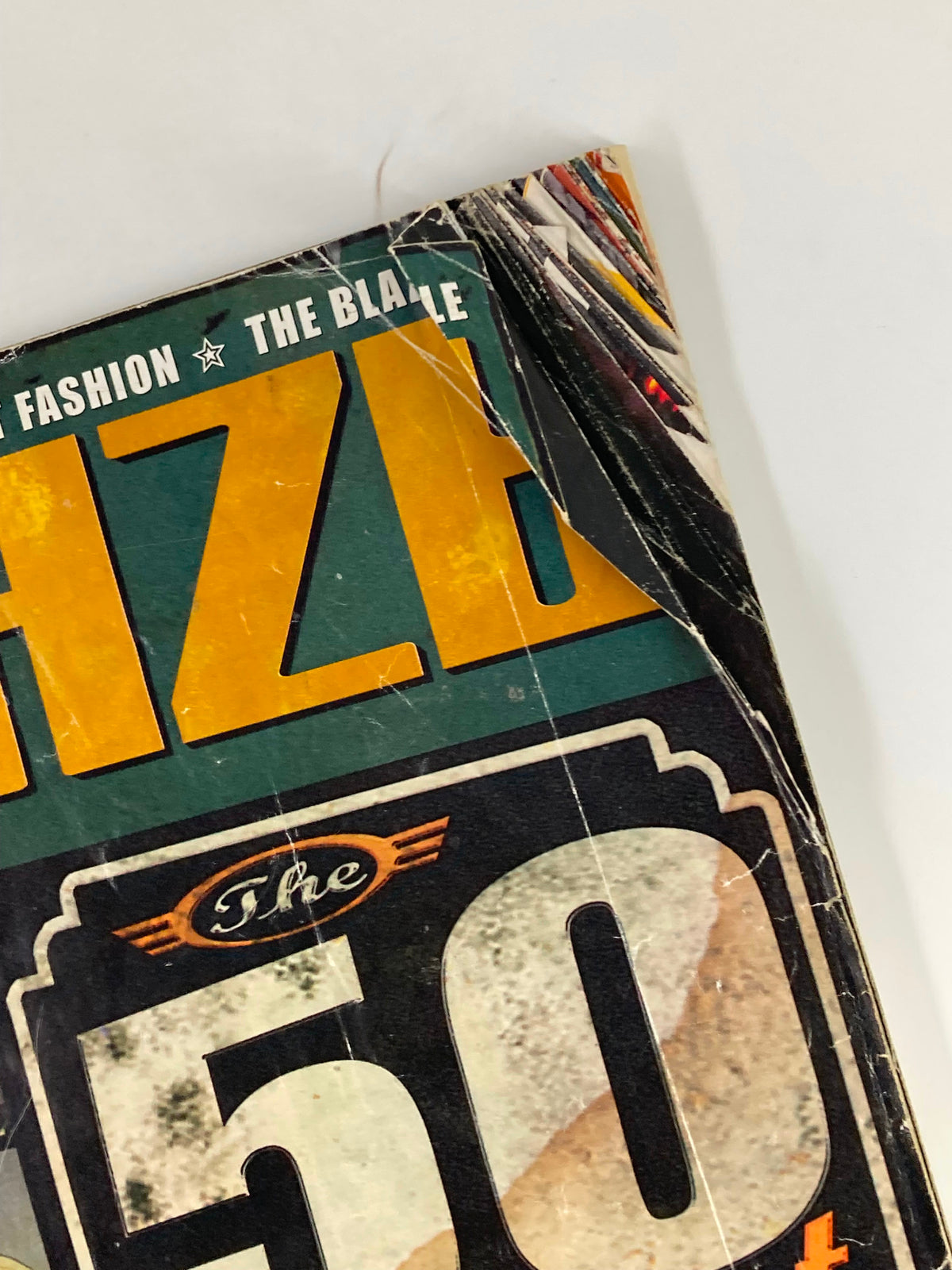 Close-up of the Blaze Vibe Magazine February 1999 cover showing 'The 50 Greatest MCs' title with visible wear indicating vintage condition.