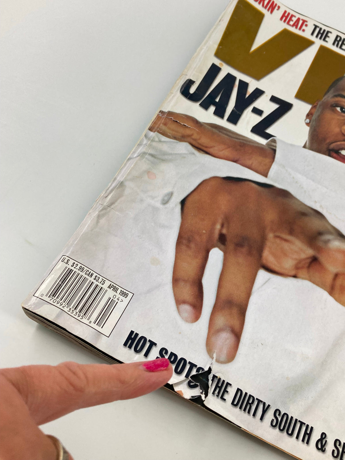 Close-up of the April 1999 Vibe Magazine cover featuring Jay-Z, highlighting the damaged edge with the title 'HOT SPOTS THE DIRTY SOUTH & SOUTH'.