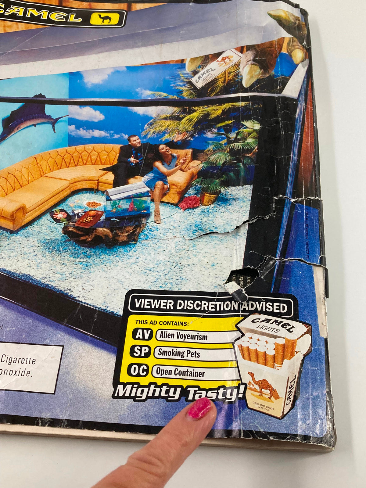 Back cover of Vibe Magazine May 1999 displaying an advertisement for Camel cigarettes. The bold text warns of viewer discretion, while the visually striking design captures the vibrant style of the late '90s.