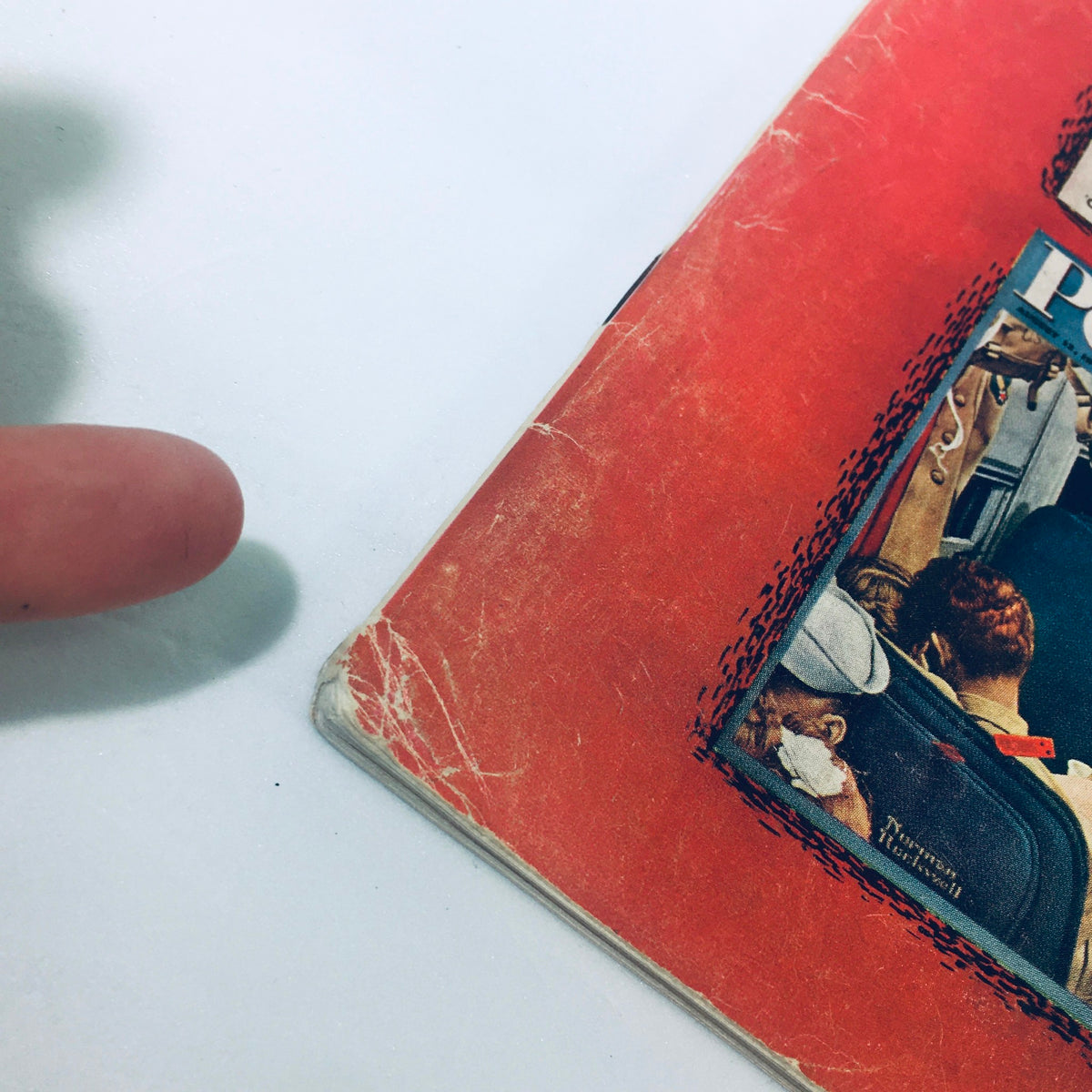 Detailed view of the edge of the VTG The Saturday Evening Post March 12, 1955 magazine showing minor wear, reflective of its vintage condition.