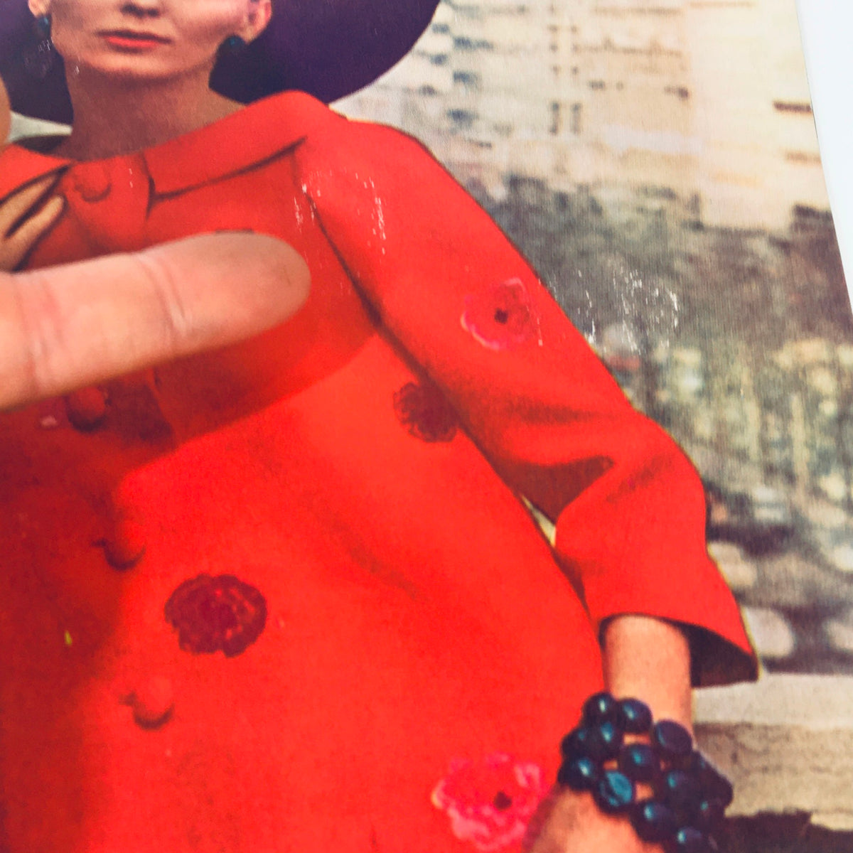Close-up of the cover of VTG The Saturday Evening Post March 16 1963 showing a model in an orange coat adorned with floral designs, highlighting fashion details from the magazine.