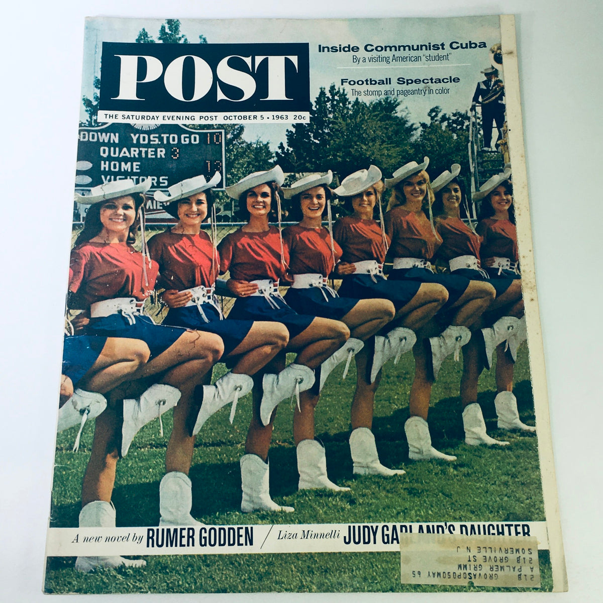 Vintage The Saturday Evening Post magazine from October 5, 1963, featuring a cover with multiple cheerleaders in vibrant uniforms, referencing 'Inside Communist Cuba' and football articles.