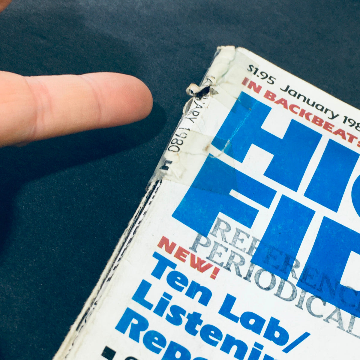 Close-up of the damaged spine of the January 1980 issue of VTG High Fidelity Magazine, highlighting its vintage condition.