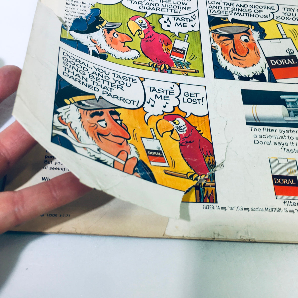 Detailed image of a vintage comic strip from the back cover of VTG Look Magazine June 1, 1971, showcasing the humorous banter between a captain and a parrot about Doral cigarettes.