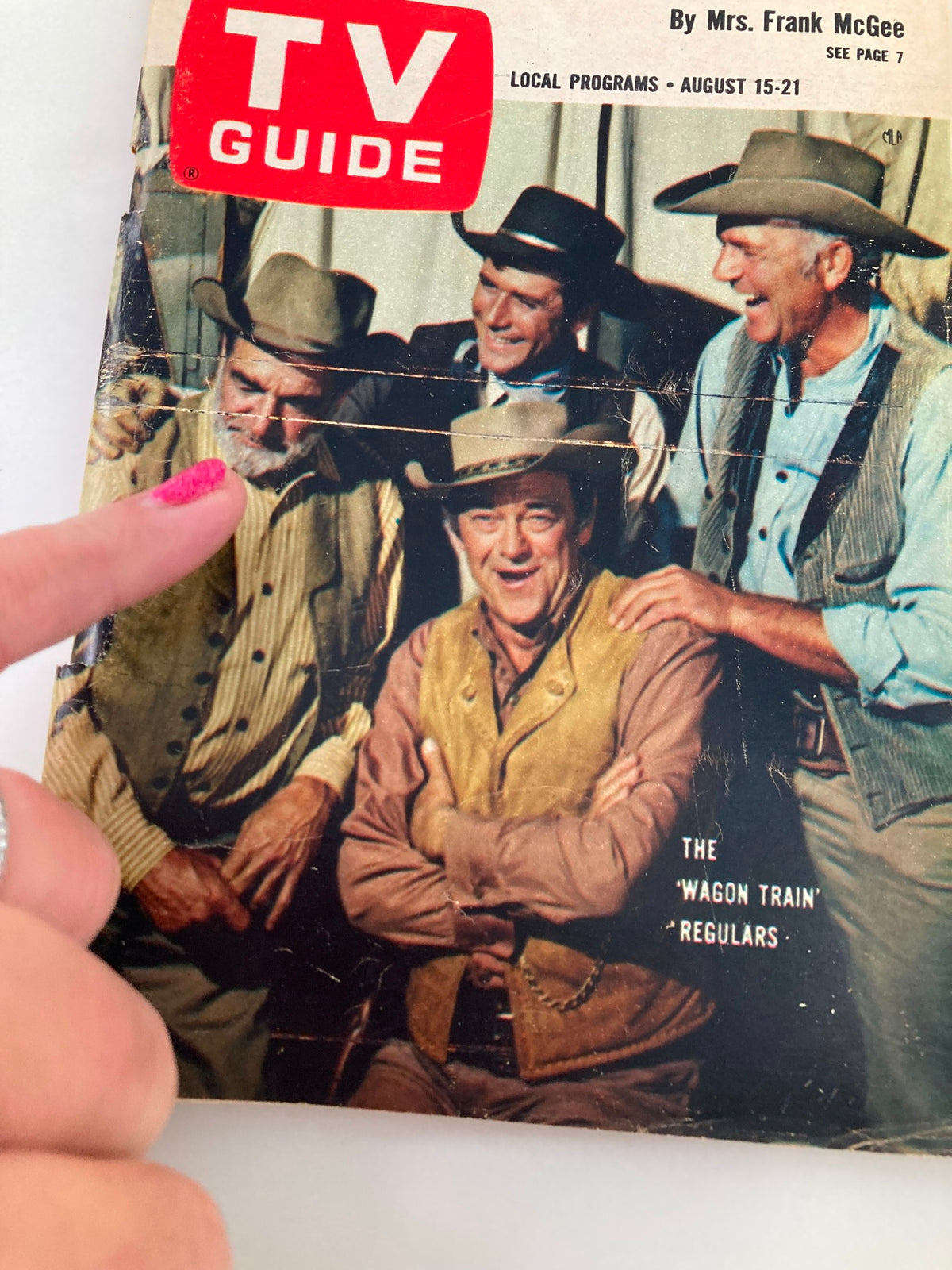 Close-up view of the TV Guide Magazine August 15 1964 cover, highlighting Frank McGrath and other Wagon Train cast members with minor creases, perfect for collectors.