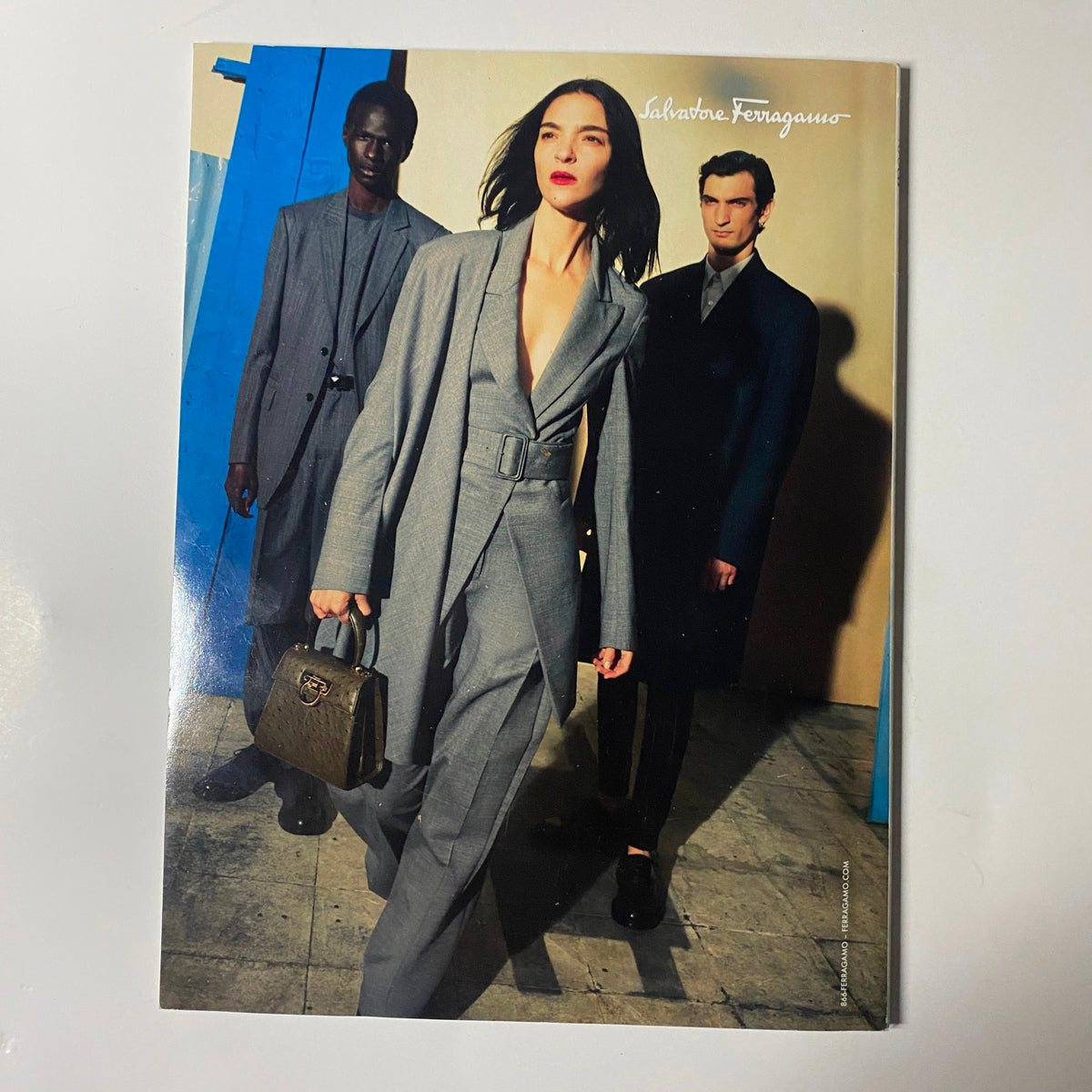 Vogue Magazine October 2020 showcasing a fashionable trio in sleek suits by Salvatore Ferragamo, exemplifying contemporary luxury and chic styling.