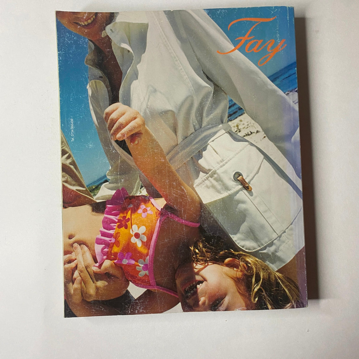 Back cover of Marie Claire Italia Magazine April 2003 featuring an advertisement for Fay, showcasing a vibrant image of a woman with a child.