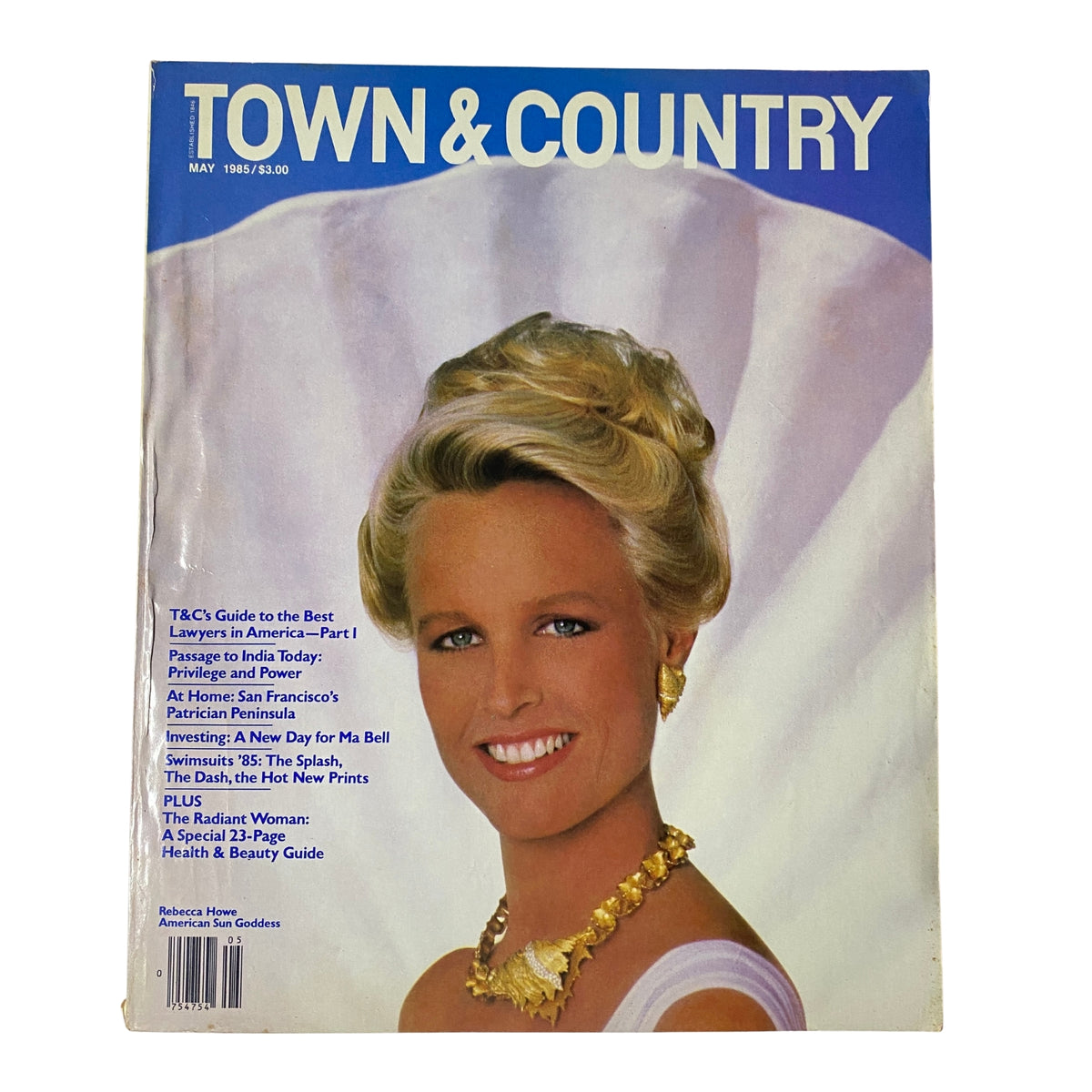 Town & Country Magazine May 1985 cover featuring Rebecca Howe, adorned with elegant seashell jewelry and styled hair, capturing the essence of 1980s glamour.