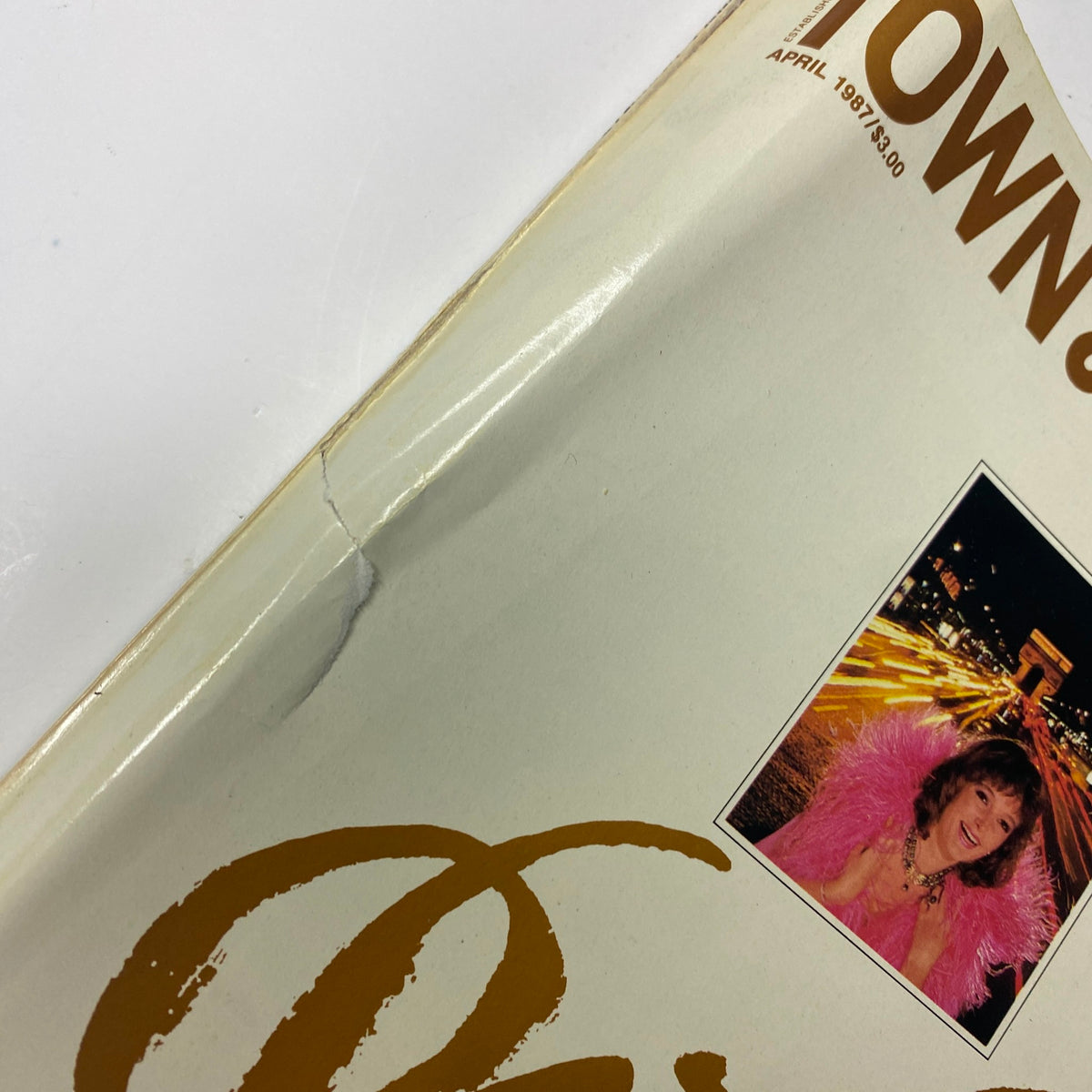 Cover detail of Town & Country Magazine April 1987 featuring Claude Chirac, showcasing a stylish pink ensemble against a vibrant night backdrop.