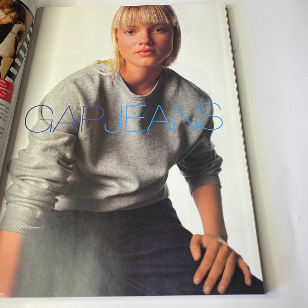Vogue Magazine August 1998 Carolyn Murphy displaying a Gap Jeans advertisement, illustrating casual style and youth culture trends of the era.