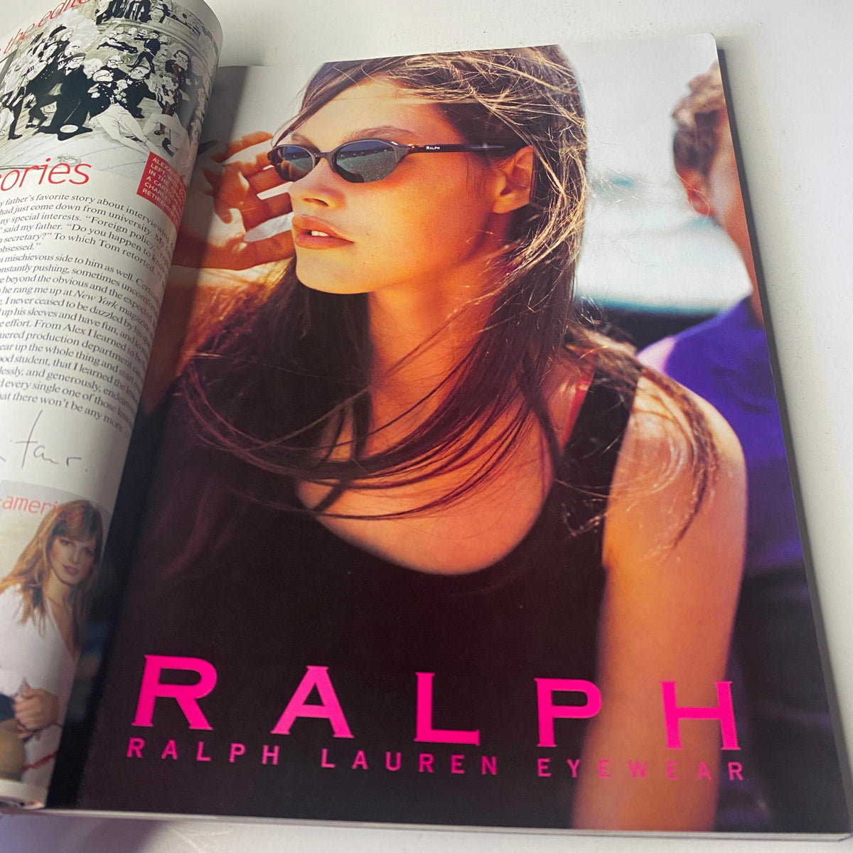 Vogue Magazine February 2000 Angela Lindvall Cover includes a Ralph Lauren Eyewear advertisement displaying a female model wearing sunglasses and a sleeveless outfit, exemplifying early 2000s chic style.