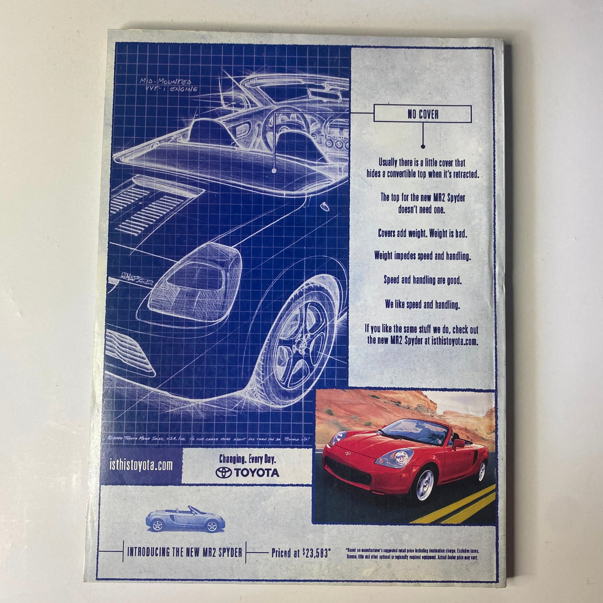 The back cover of August 2000 Vogue Magazine featuring a Toyota MR2 Spyder advertisement, presenting a blue print design layout with highlights about the sporty vehicle.