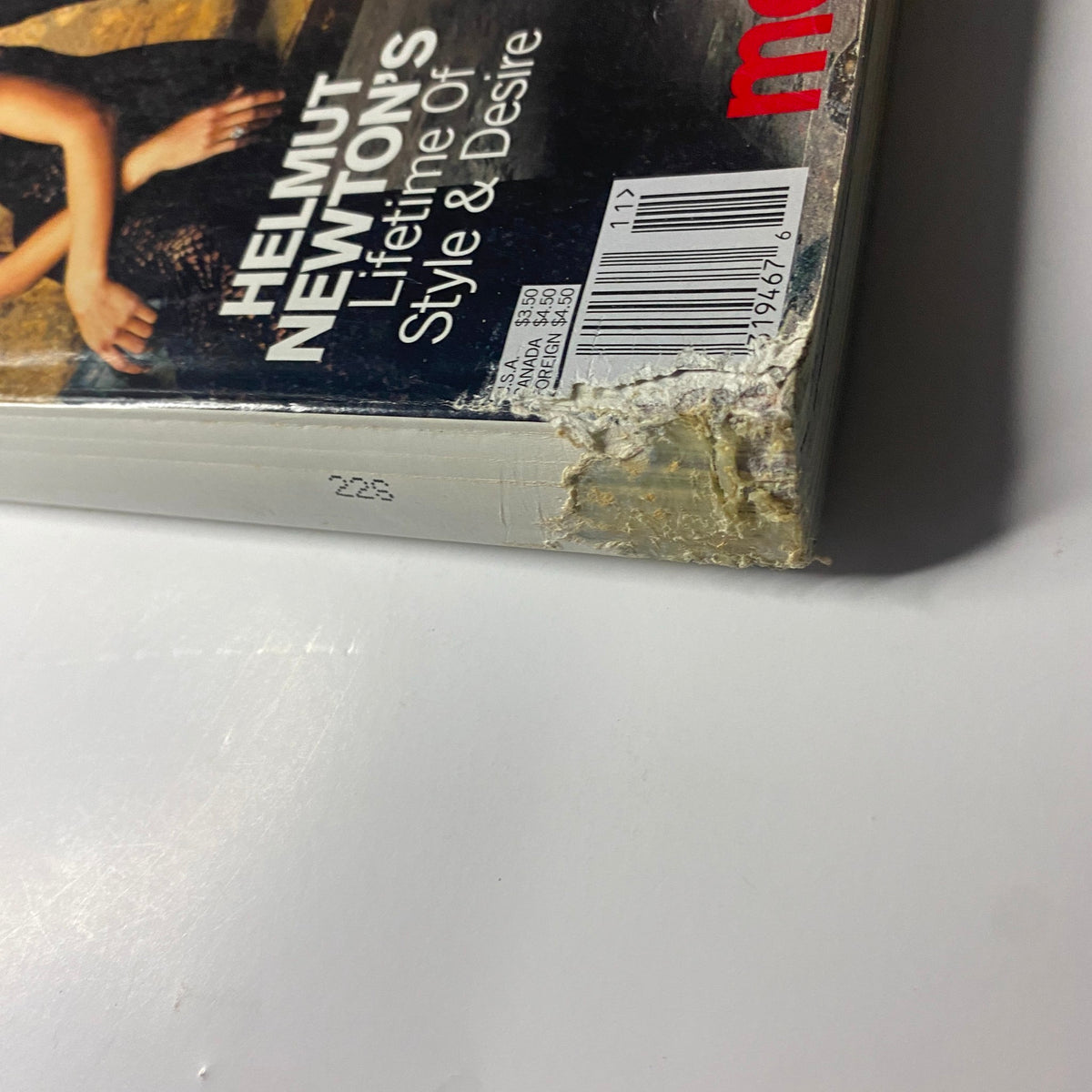 Close-up of the damaged corner of Vogue Magazine November 2000, featuring cover models Carmen Kass, Angela Lindvall, Frankie Rayder, and Maggie Rizer. Highlights the magazine's vintage condition for collectors.