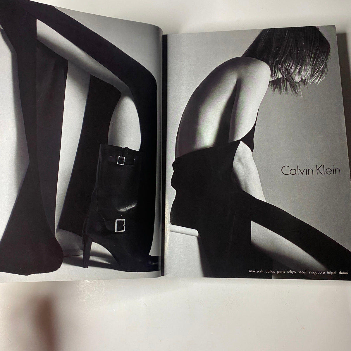 Inside Vogue Magazine September 2001, this black-and-white editorial showcases Calvin Klein's contemporary fashion, highlighting innovative designs and bold footwear.