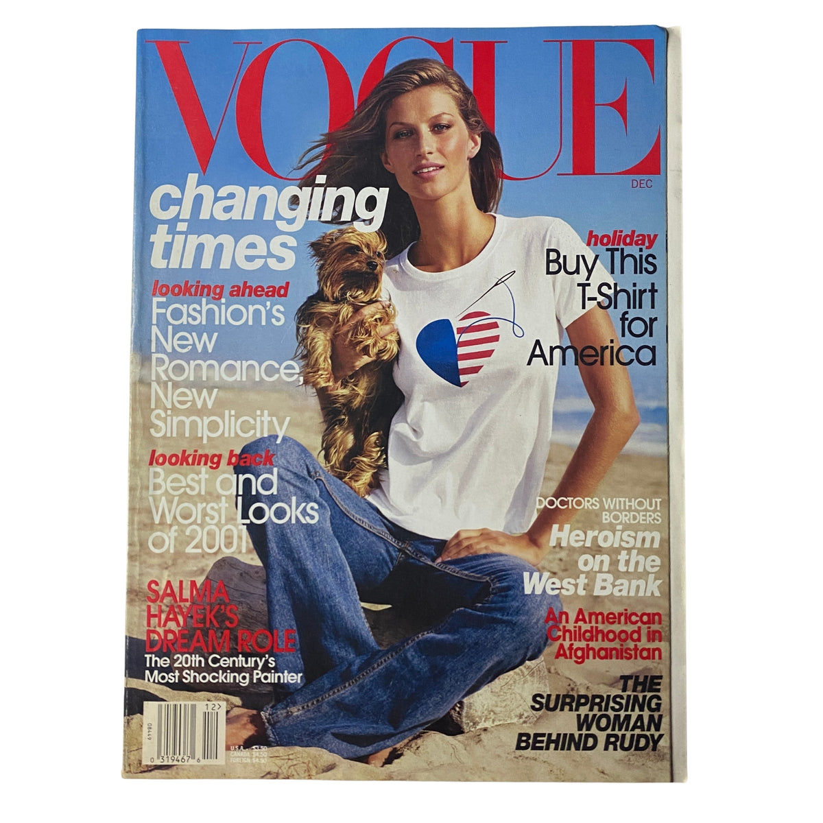 Vogue Magazine cover from December 2001 featuring Gisele Bündchen with a golden retriever, showcasing the theme 'changing times' and discussing fashion's new romance and simplicity. Very good condition, no label.