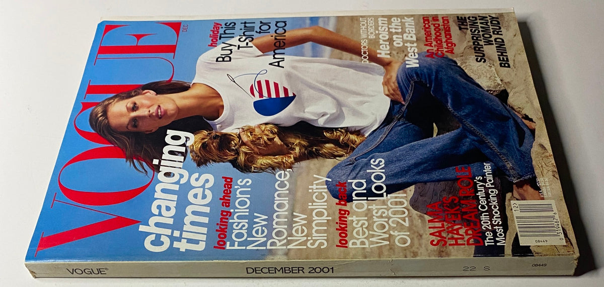 December 2001 issue of Vogue Magazine featuring Gisele Bündchen on the cover with a golden retriever. The cover highlights 'changing times' in fashion and includes promotional text for a T-shirt for America. In very good condition.