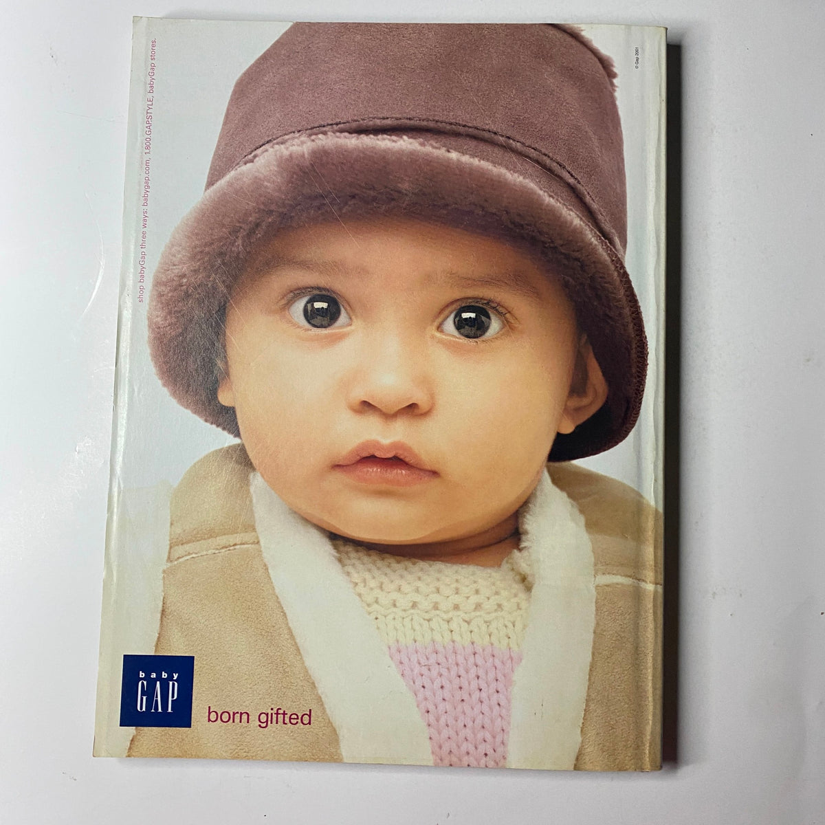 Baby Gap advertisement featuring a child wearing winter clothing, included in Vogue Magazine December 2001 Gisele Bündchen Cover.