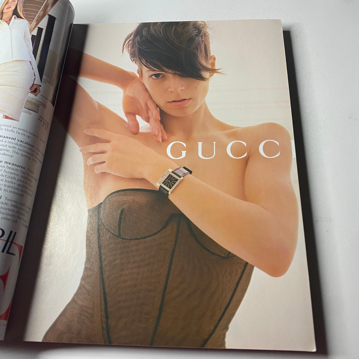 Fashion editorial page from Vogue Magazine April 2001 featuring a striking ad for Gucci, showcasing contemporary fashion and design trends.