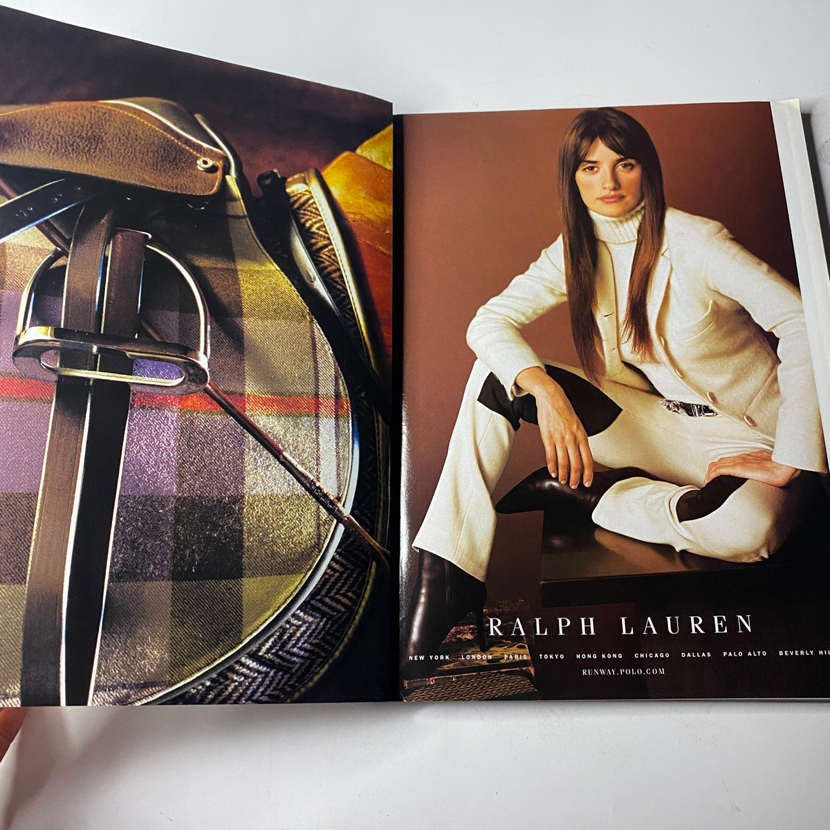 Vogue Magazine August 2001 showcasing a Ralph Lauren advertisement with a model in a chic white suit paired with equestrian-inspired elements, perfectly illustrating early 2000s fashion elegance.