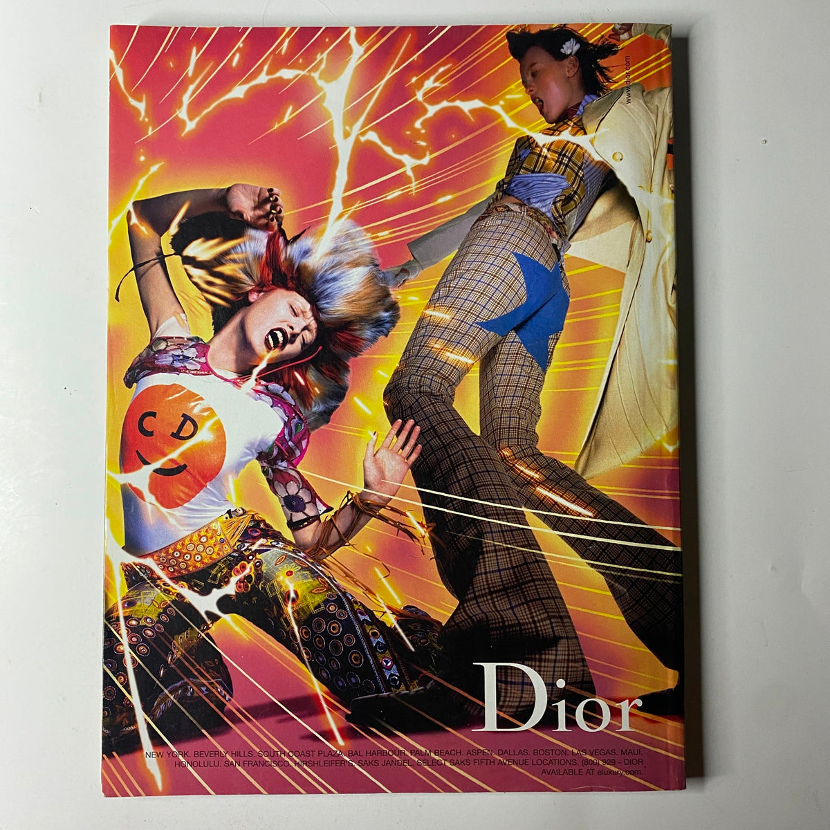 Vogue Magazine August 2001 highlighting a vibrant Dior advertisement, depicting models in dynamic poses with bright colors and bold patterns, capturing the essence of contemporary fashion in the early 2000s.