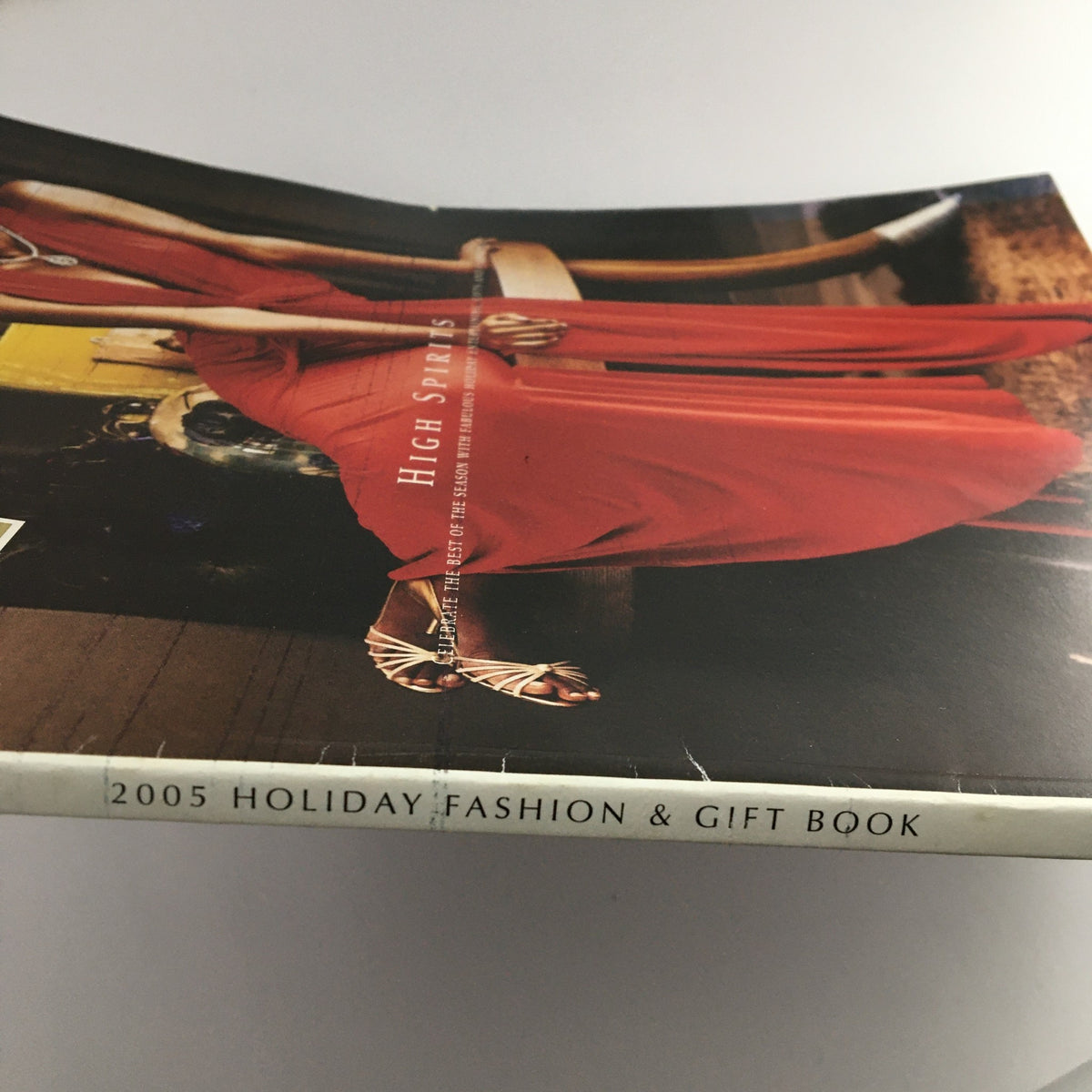 Side view of the W Magazine 2005 Holiday Fashion & Gift Book High Spirits, showcasing its cover and spine design.