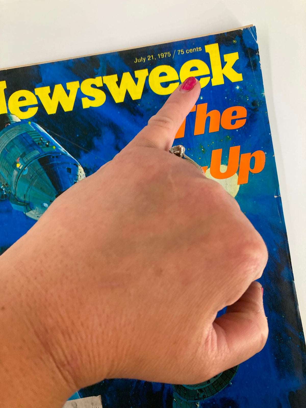 Close-up view of the VTG Newsweek Magazine from July 21, 1975, highlighting the title 'The Link-Up' with a finger pointing to the magazine header.