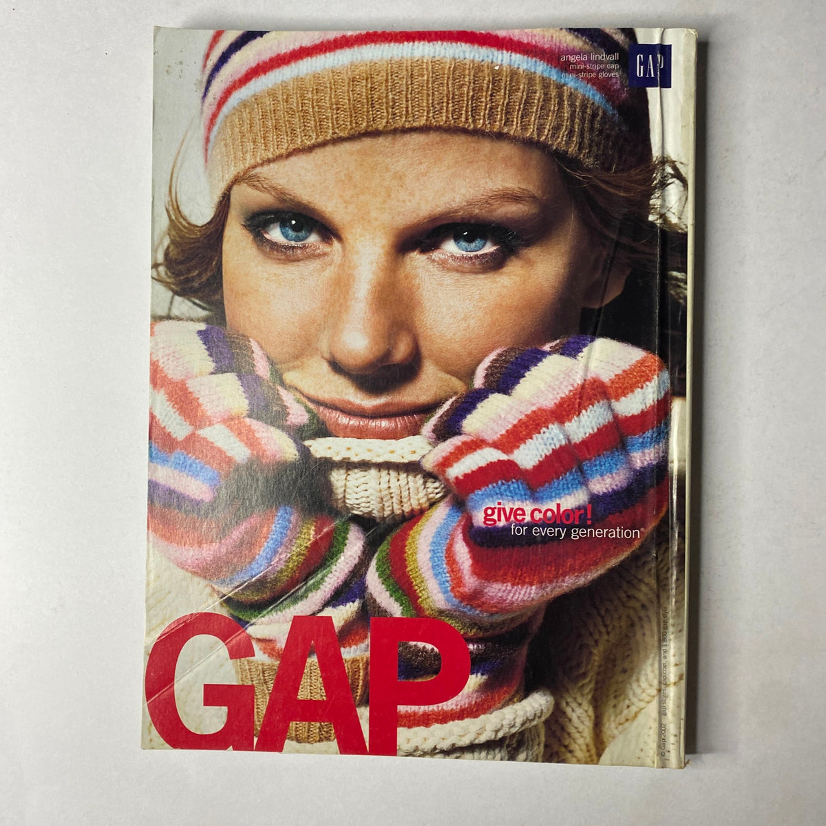 Vogue Magazine December 2002 Halle Berry Cover No Label - Cover image of GAP ad featuring a model wearing colorful striped gloves and winter attire.