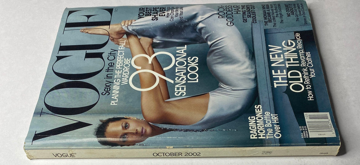 Vogue Magazine October 2002 Christy Turlington Cover showcasing her iconic pose, highlighting fashion trends and style insights from the early 2000s.