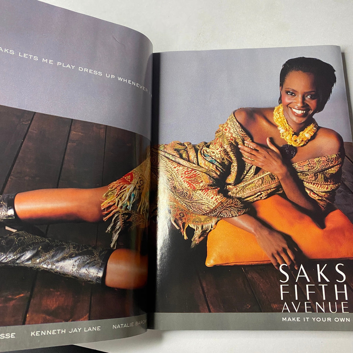 Vogue Magazine October 2002 featuring a fashion advertisement for Saks Fifth Avenue, showcasing luxury clothing and accessories.