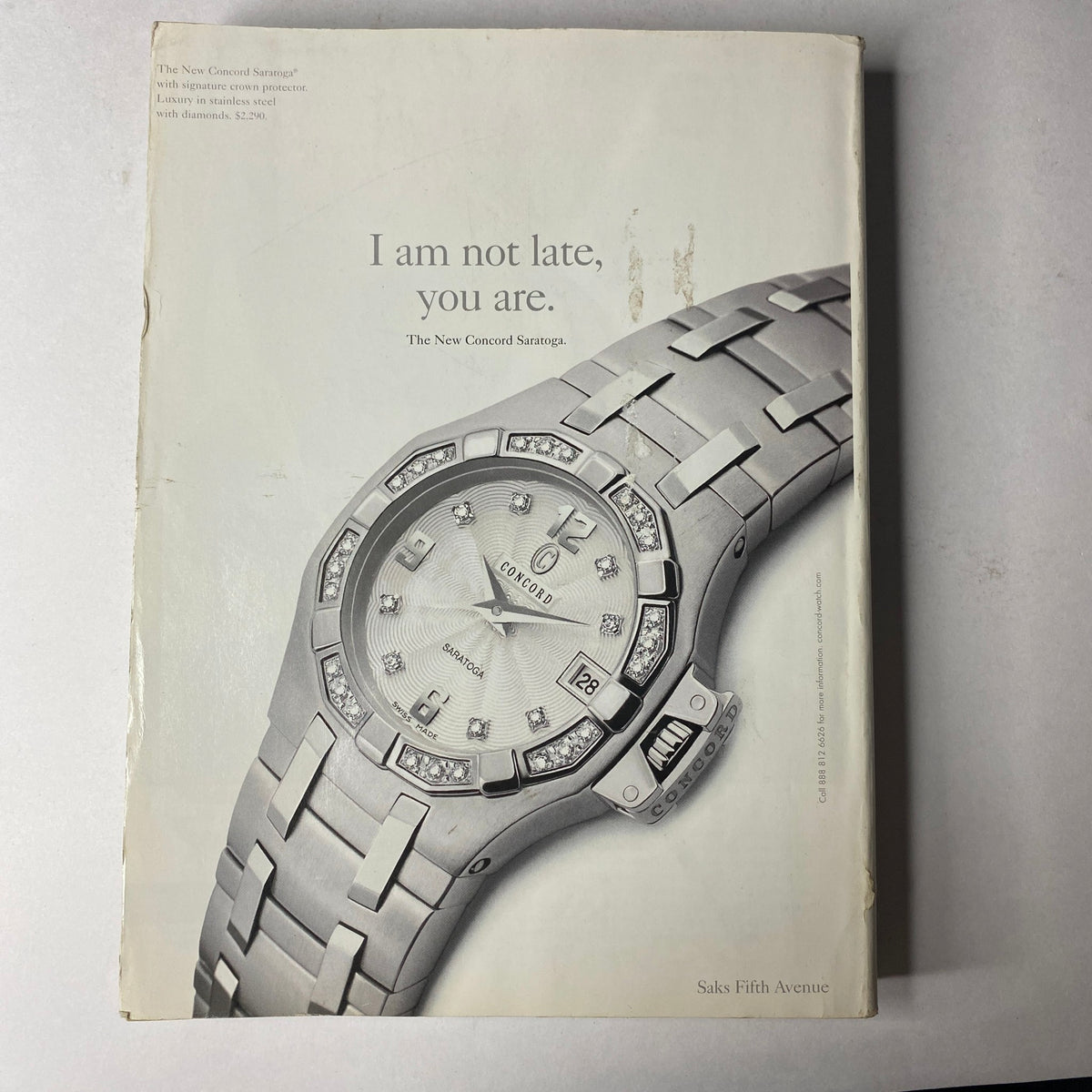 Vogue Magazine September 2002 with a sleek advertisement for Saks Fifth Avenue showcasing a luxury watch, emphasizing elegance and sophistication.