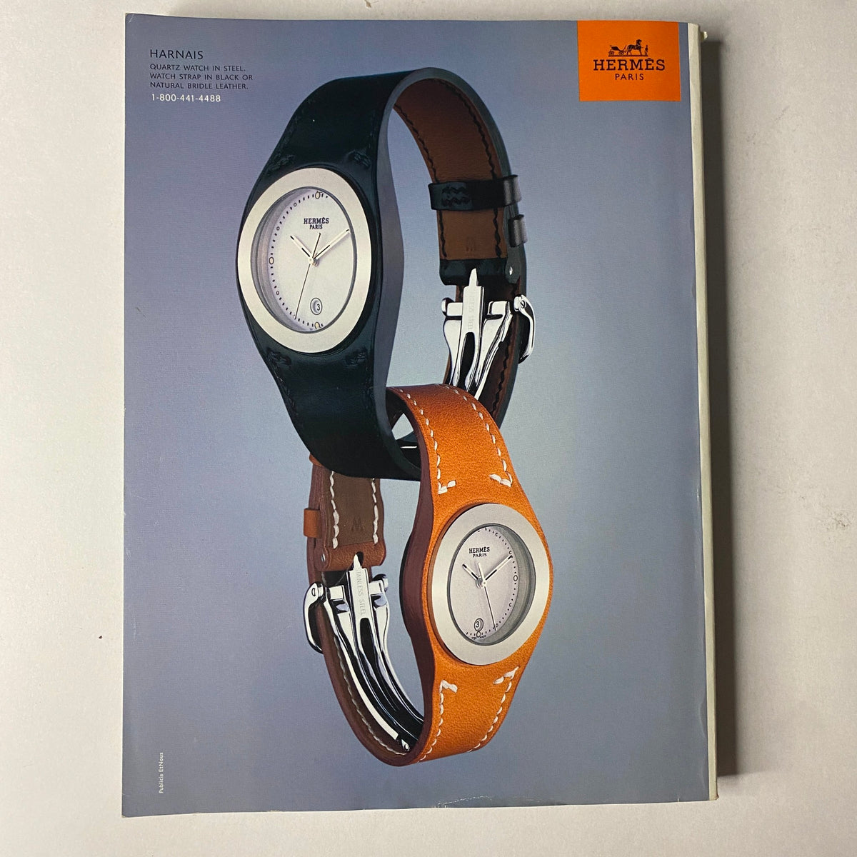 Hermès advertisement displaying two stylish watches with leather straps in black and orange, from the Vogue Magazine November 2002 Catherine Zeta-Jones & Renée Zellweger issue.