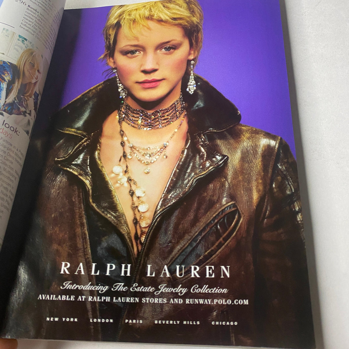 Vogue Magazine October 2003 Gwyneth Paltrow Cover No Label advertisement for Ralph Lauren's Estate Jewelry Collection, showcasing a model in a leather jacket adorned with exquisite jewelry.