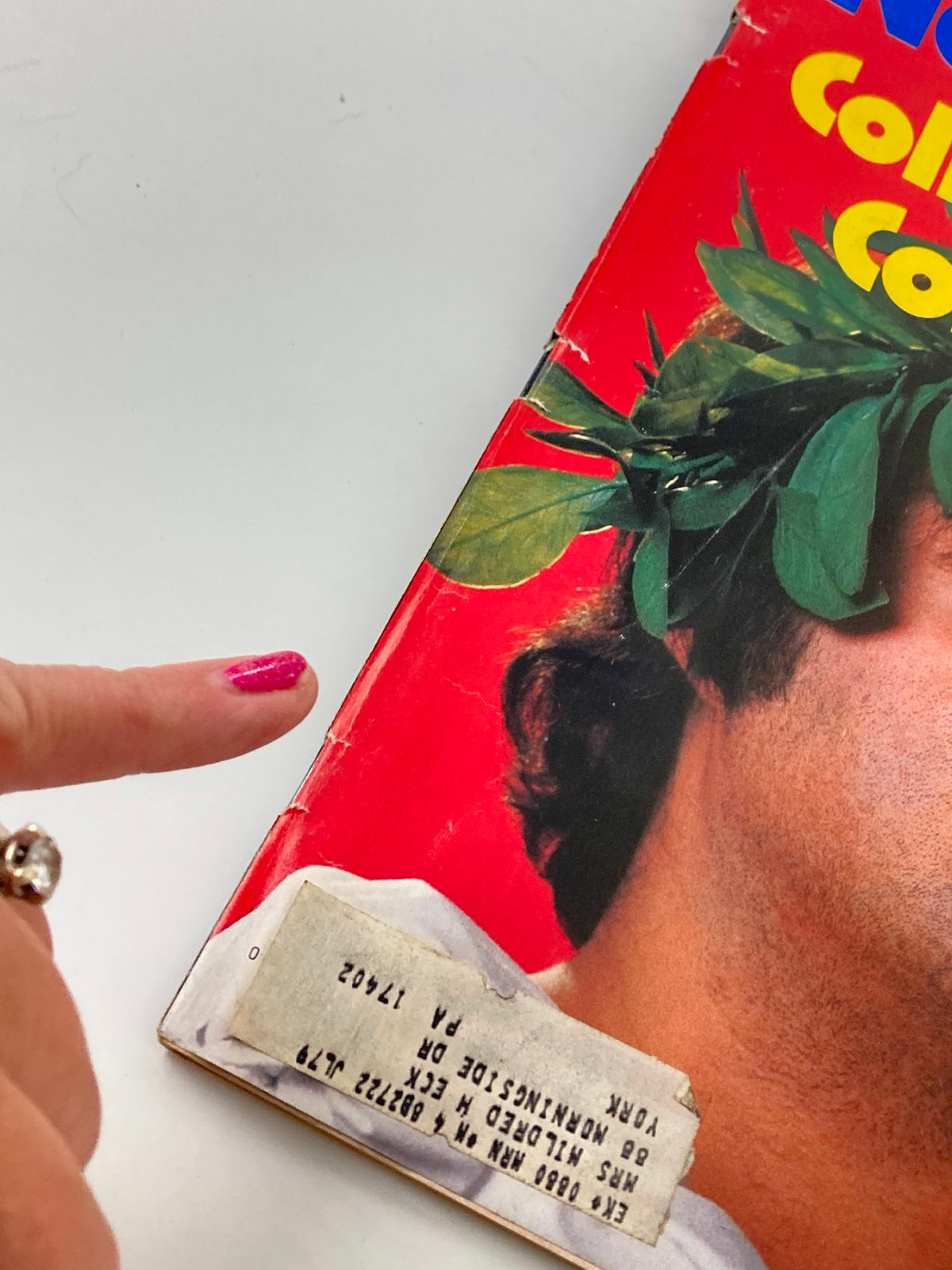 Close-up of the cover of VTG Newsweek Magazine October 23 1978 featuring John Belushi, showcasing vintage humor with a vibrant red background and a label indicating its original location.