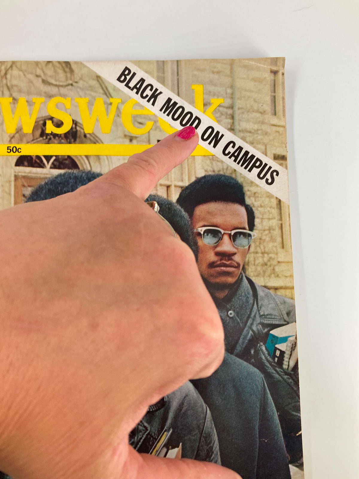 Close-up of VTG Newsweek Magazine February 10 1969 highlighting the 'Black Mood On Campus' title with a finger pointing to it, showcasing vintage magazine details.