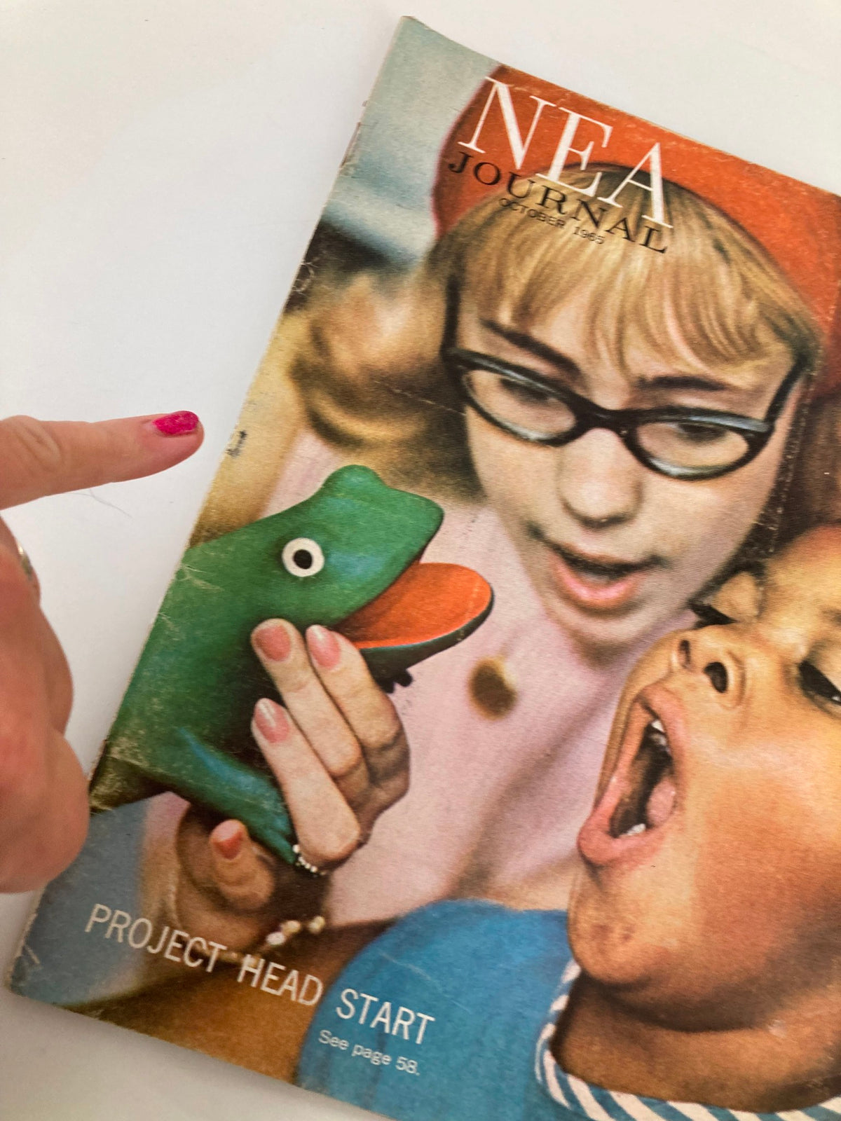 Close-up of the VTG NEA Journal Magazine October 1965 cover highlighting a woman showing a toy frog to a child, emphasizing interactive learning.