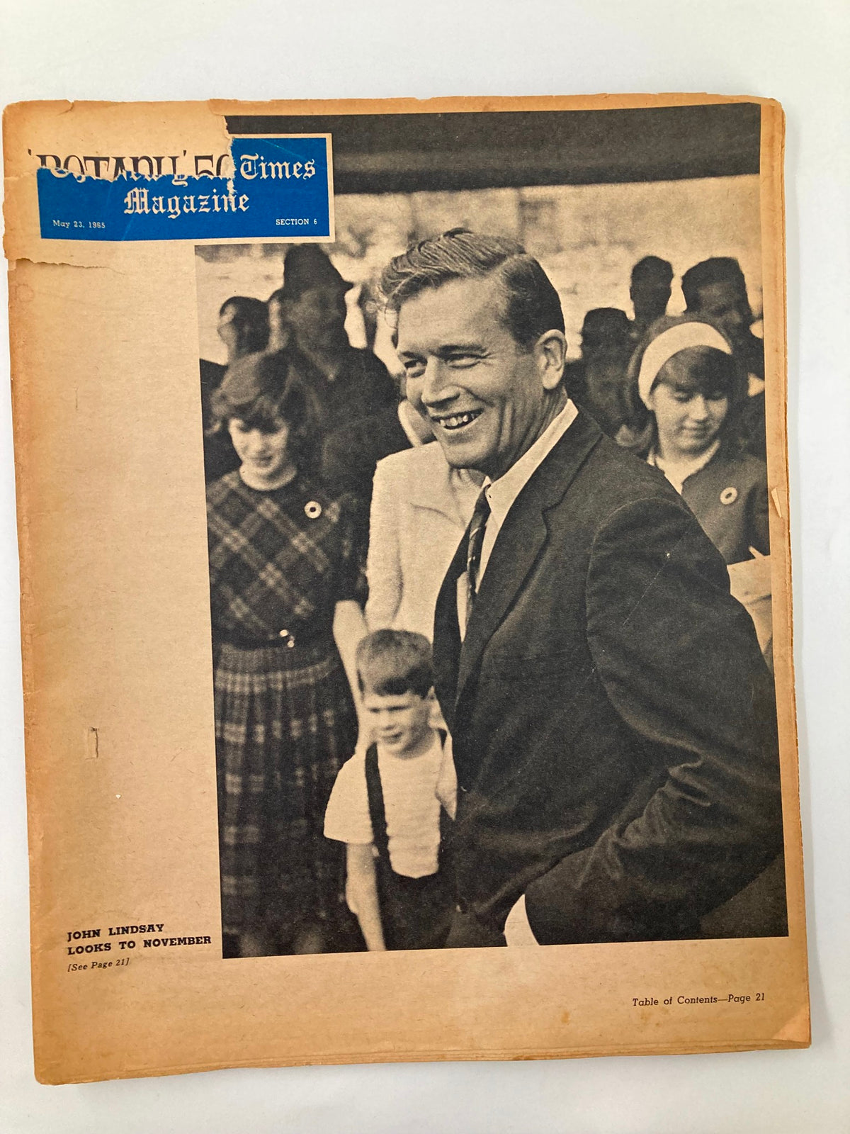 Cover of VTG The New York Times Magazine dated May 23, 1965, featuring John Lindsay. The image depicts Lindsay smiling in a crowd. The magazine includes vintage elements and shows signs of age, enhancing its collectible appeal.