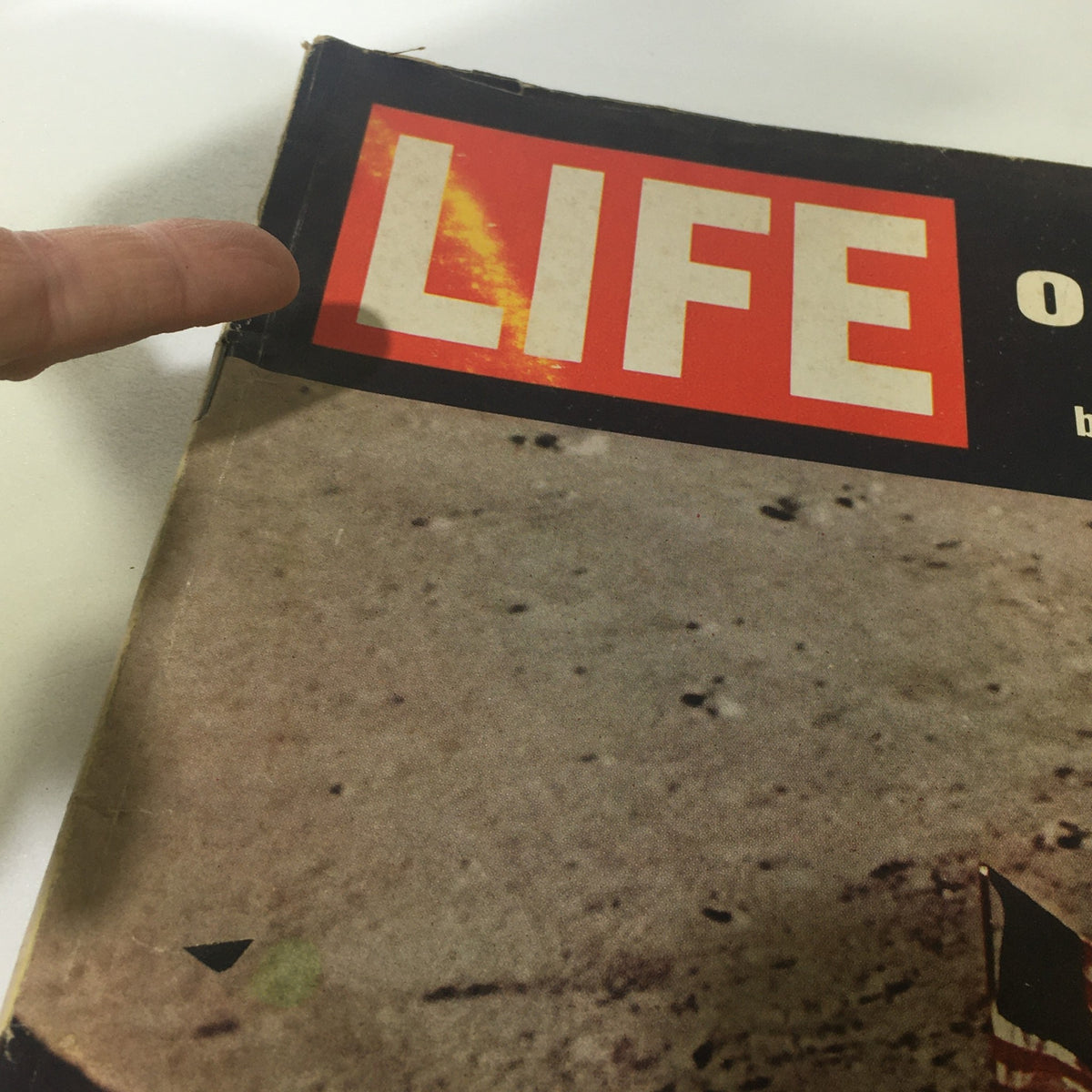 Close-up of the top corner of VTG Life Magazine August 8 1969, showing the title 'LIFE on the Moon' with details of the magazine's wear.