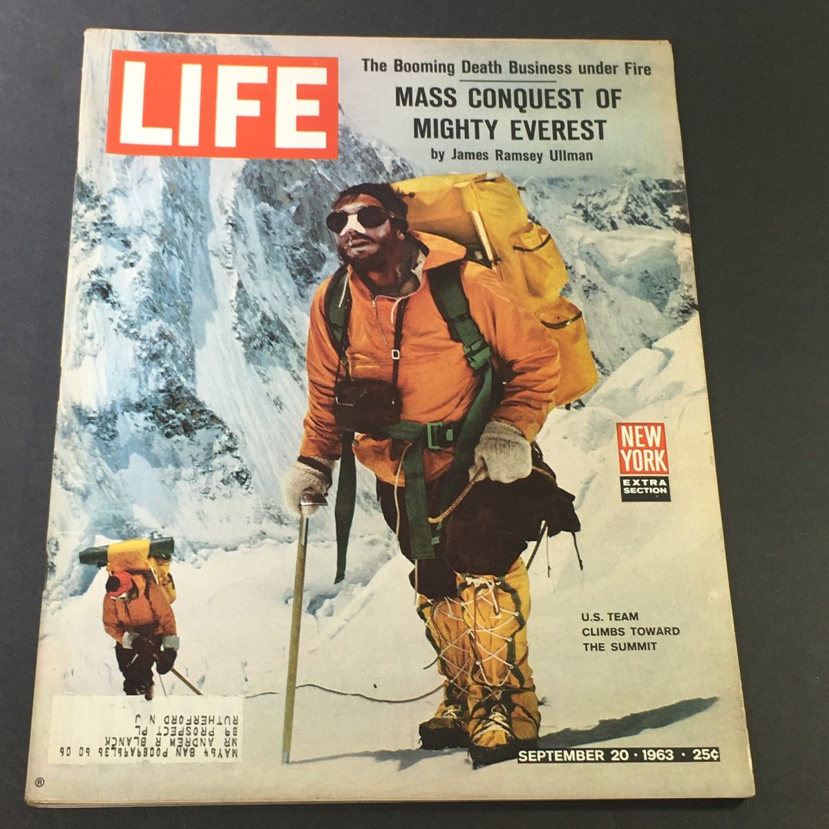 Cover of Life Magazine from September 20, 1963, featuring the title 'Mass Conquest of Mighty Everest' by James R. Ullman, showcasing a mountaineer in a bright orange jacket on a snowy mountain, capturing the adventurous spirit of the 1960s exploration.