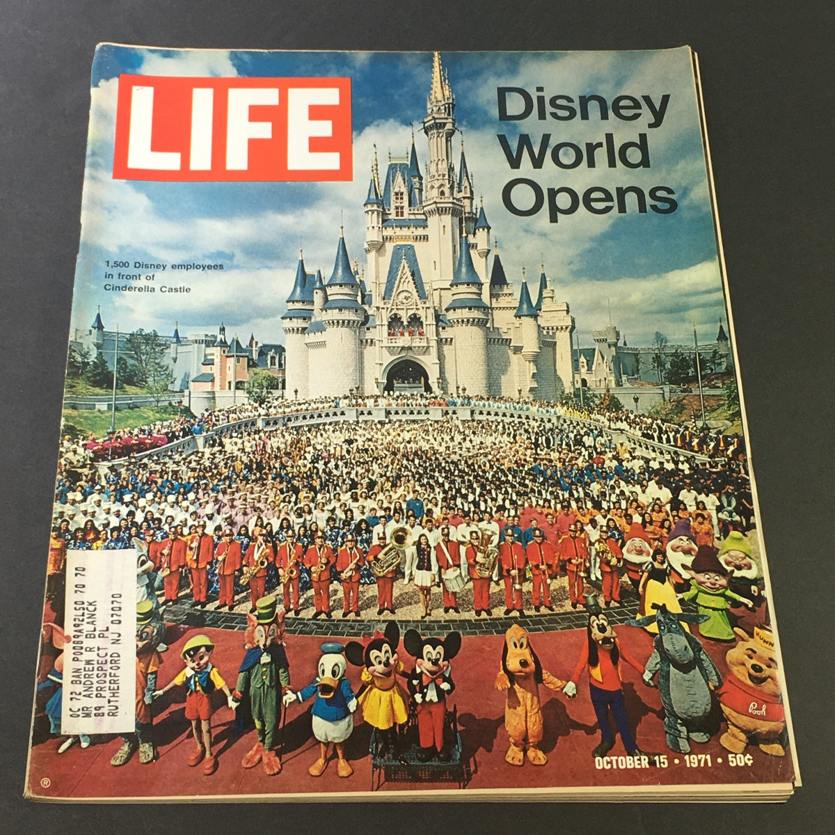 Vintage Life Magazine cover from October 15, 1971, celebrating the grand opening of Disney World, the Happiest Place on Earth, featuring Cinderella Castle and a large crowd of Disney characters and employees.
