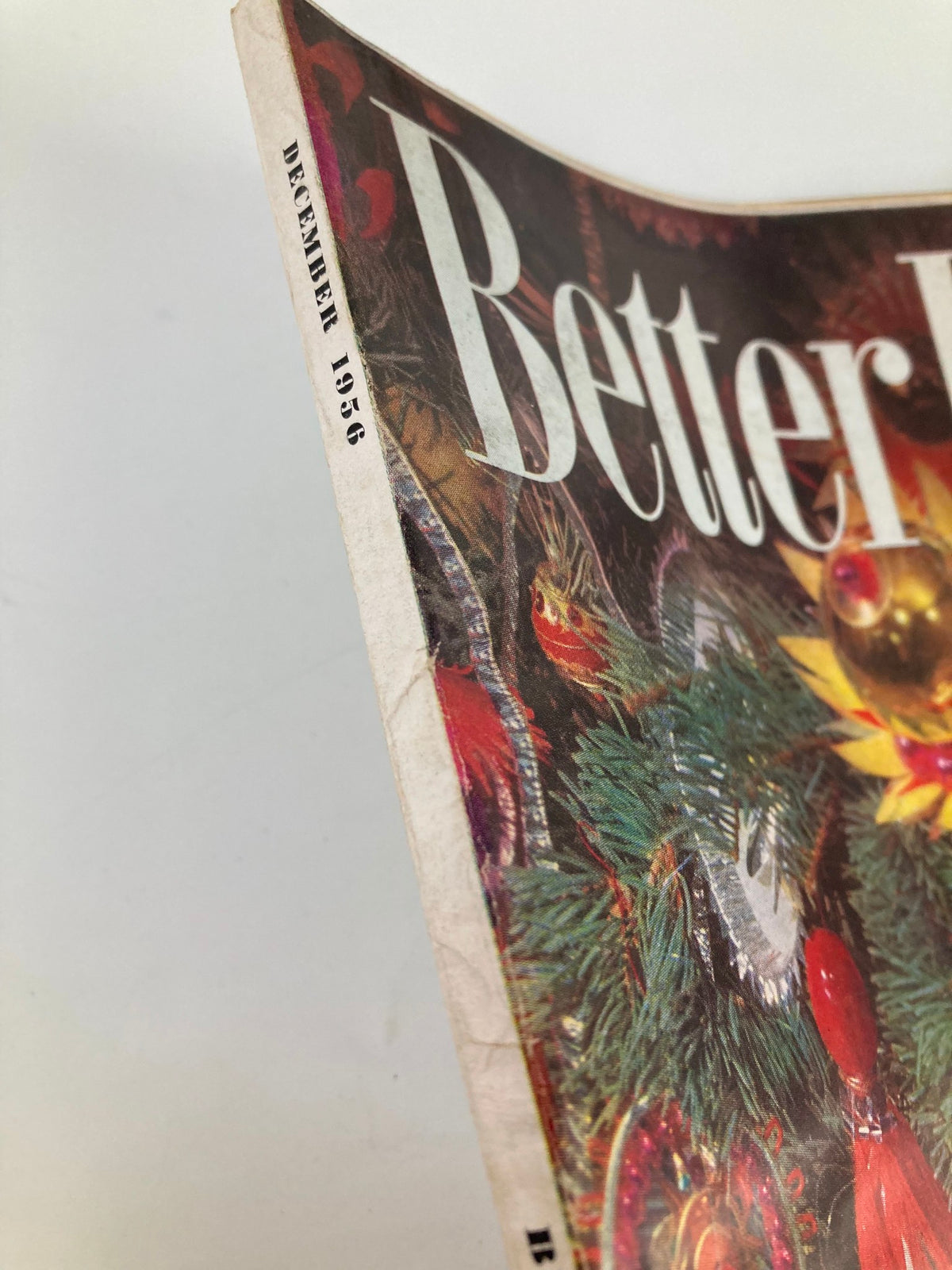 Side view of the VTG Better Homes and Gardens Magazine December 1956, highlighting its aged but charming spine with 'December 1956' printed, showcasing its vintage appeal.