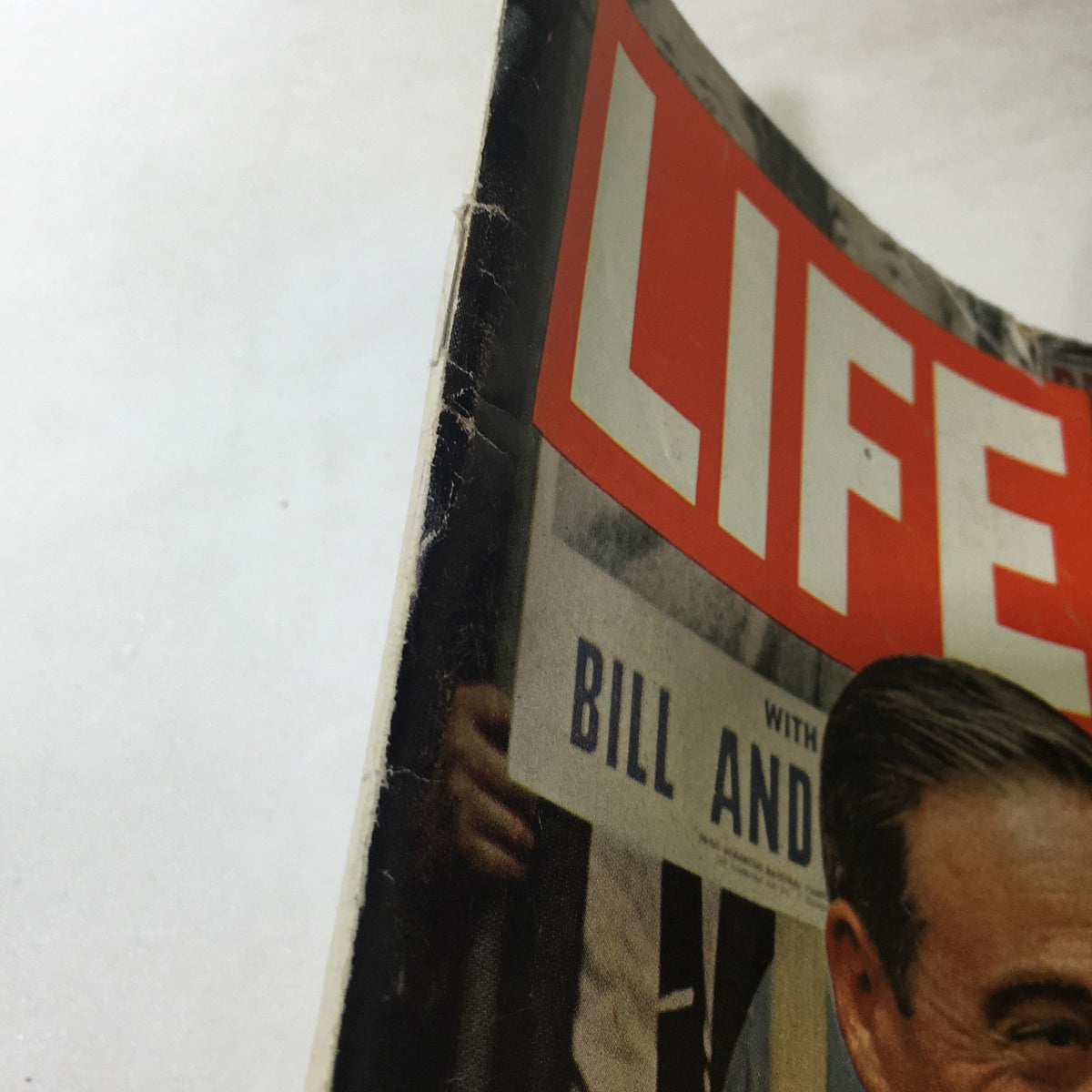 Close-up of the cover of a vintage Life Magazine from June 26, 1964, featuring the title 'LIFE' and a glimpse of a prominent story about 'The Scrantons A Family's Uphill Fight'.