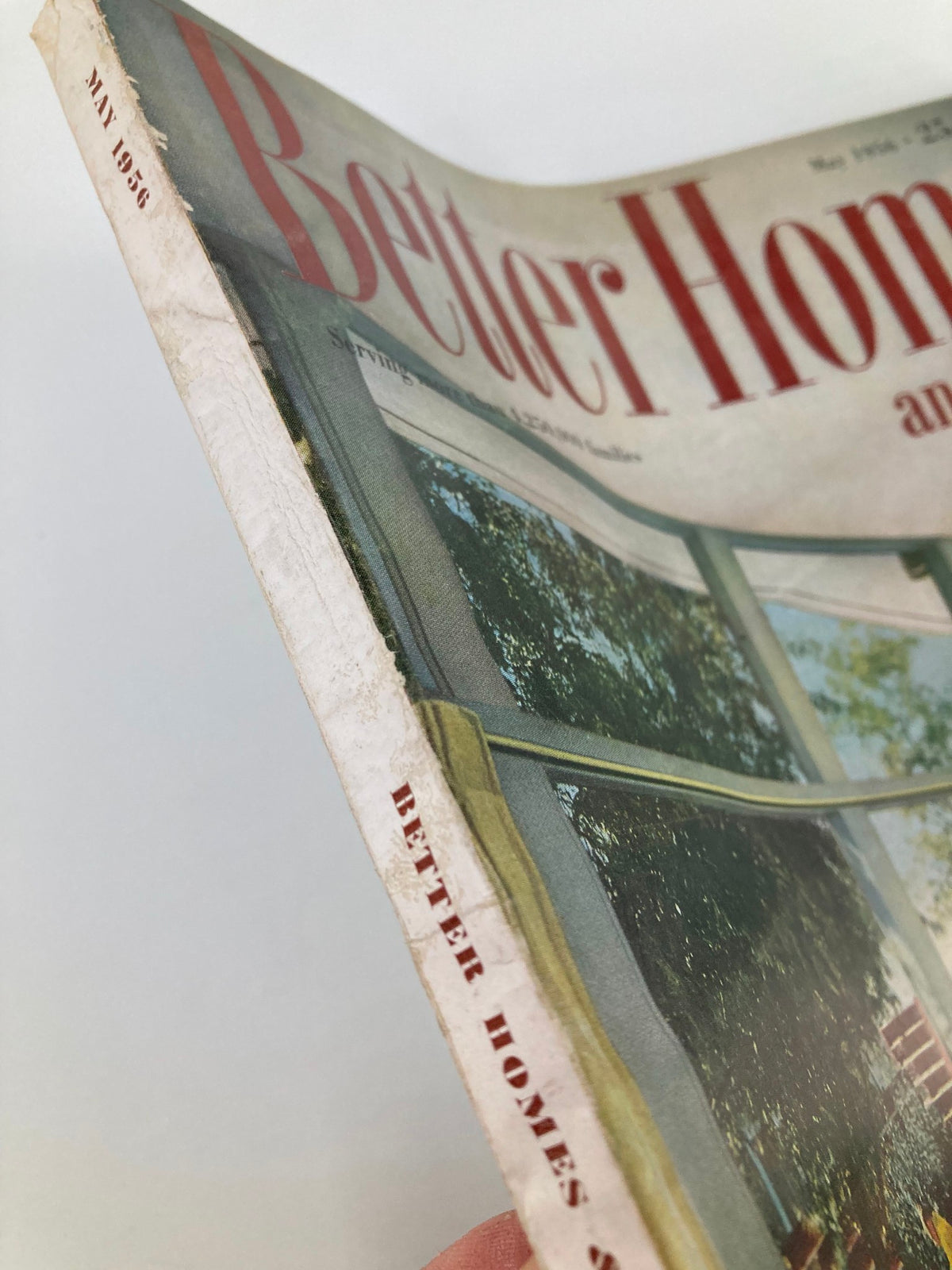 Side view of VTG Better Homes and Gardens Magazine May 1956, showing the magazine's title and edge wear indicative of its vintage age.