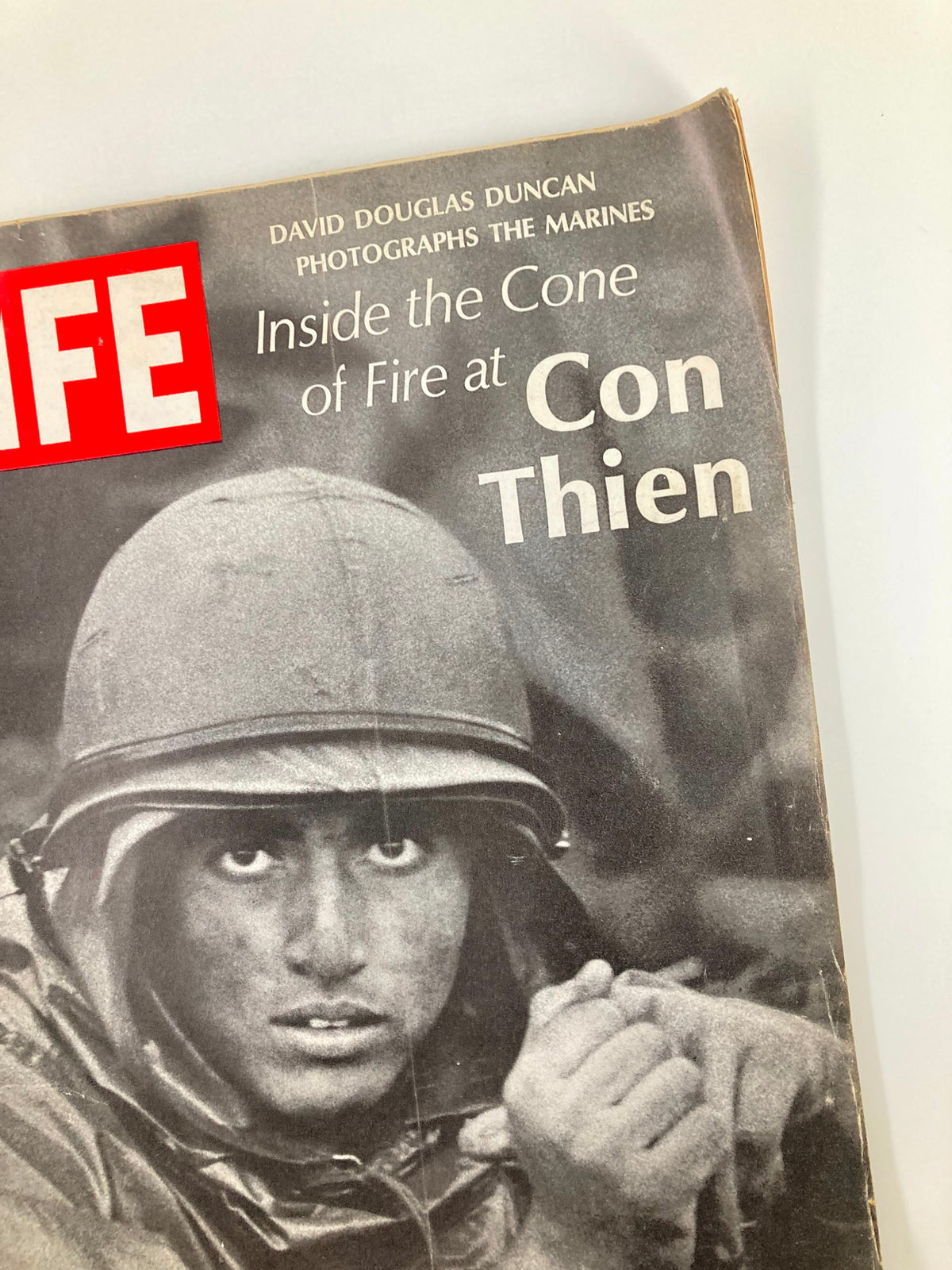 Close-up view of the cover of Vintage Life Magazine, October 27, 1967, showcasing the soldier's face and the magazine title 'Inside The Cone of Fire at Con Thien'.