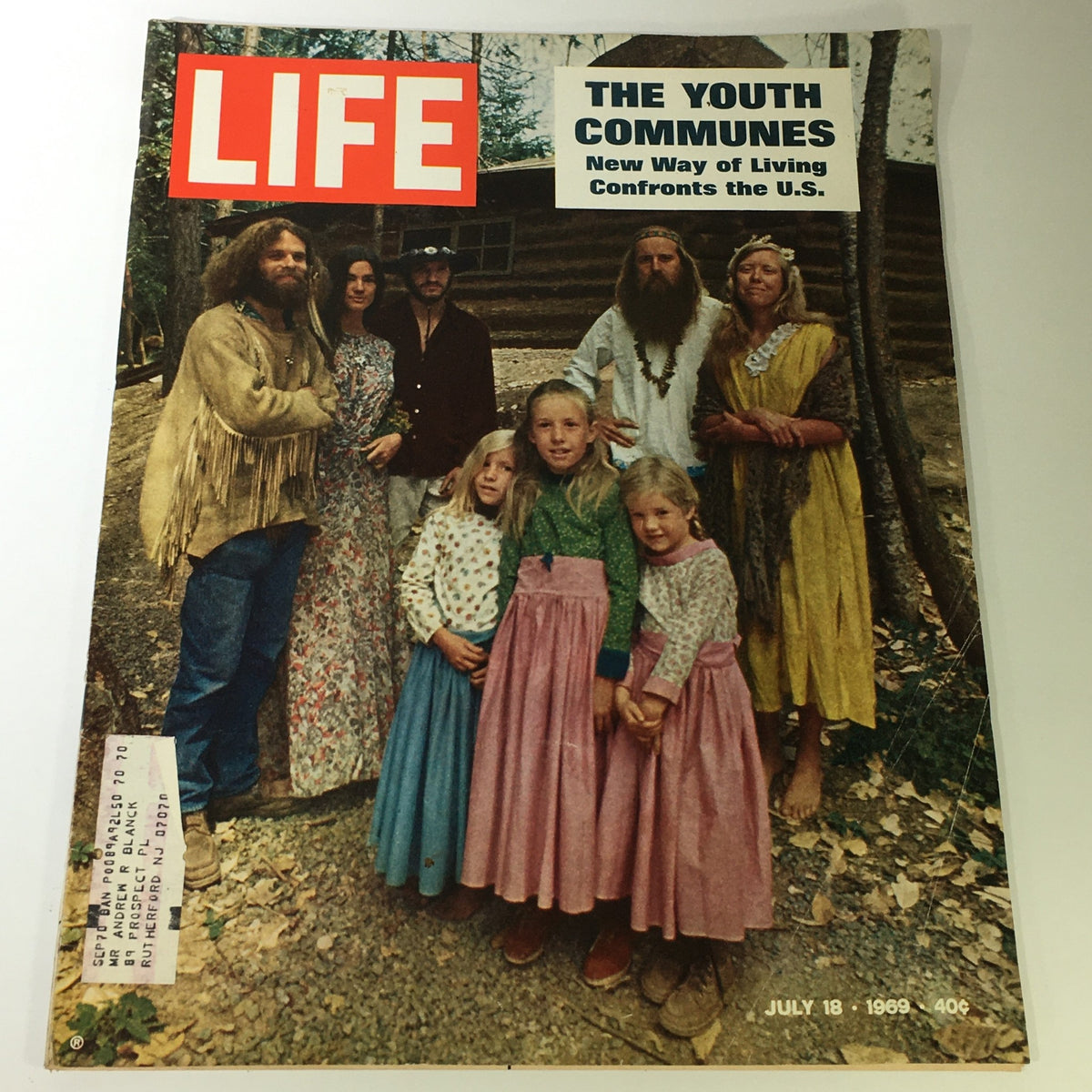 Vintage Life Magazine cover from July 18, 1969, titled 'The Youth Communes: New Way of Living Confronts the U.S.', featuring a group of individuals in communal attire standing in front of a rustic background, highlighting the youth movement of the 1960s.