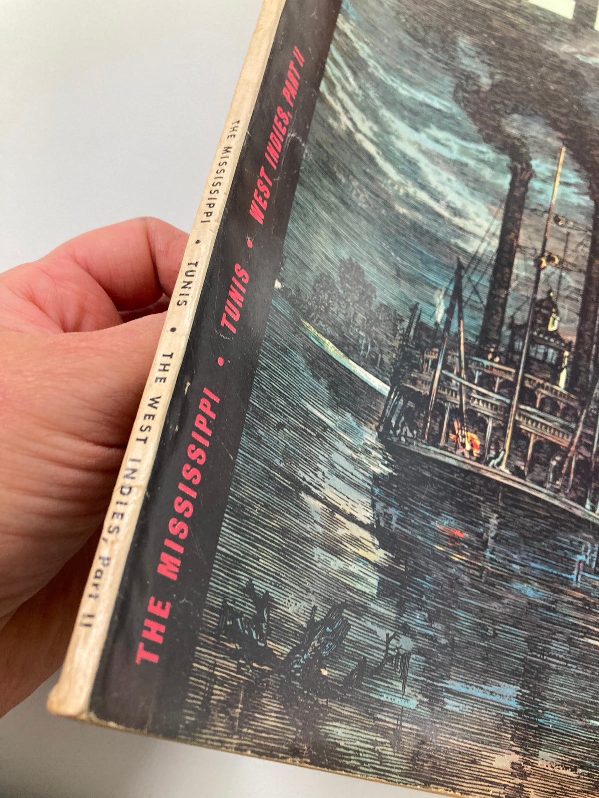 Side view of the Vintage Holiday Magazine March 1949 Vol 5 #3 Moonlight on the Mississippi highlighting the spine with titles 'The Mississippi', 'Tunis', and 'West Indies, Part II'.